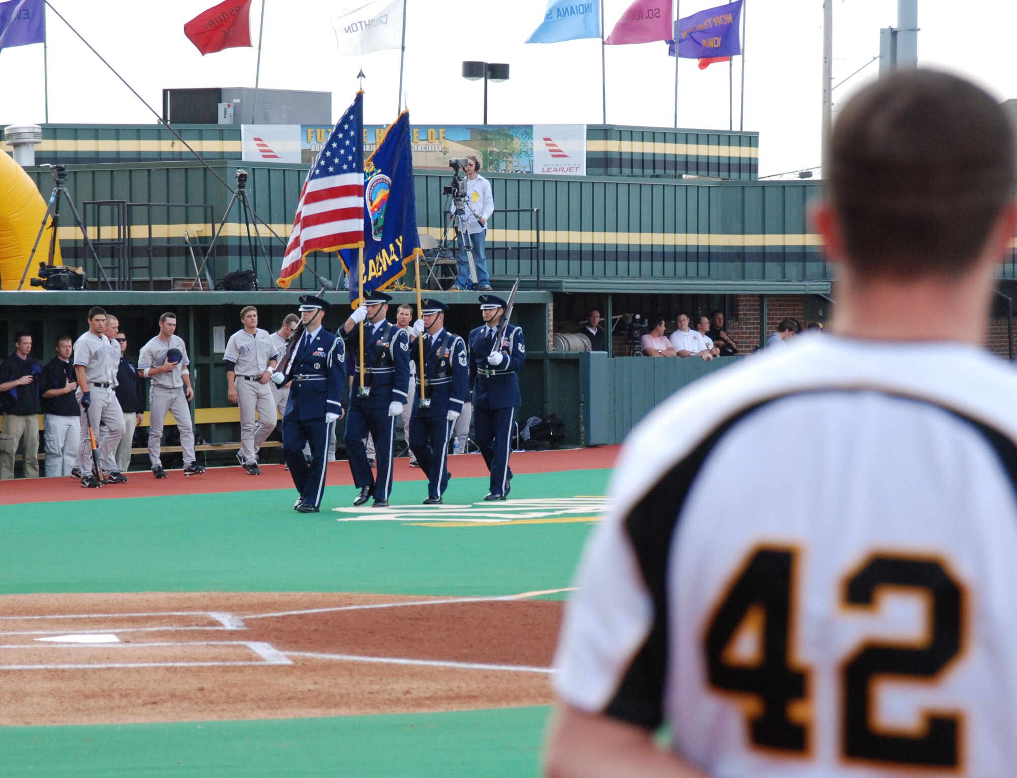 WICHITA, Kan. -- Members of the Wichita State University Shockers baseball team and fans watch as Honor Guard members from the 184th Intelligence Wing at McConnell Air Force Base present the “Colors” during a Military Appreciation Night game at Wichita University’s Eck Stadium, April 29. (Photo by Airman 1st Class Jessica Lockoski)