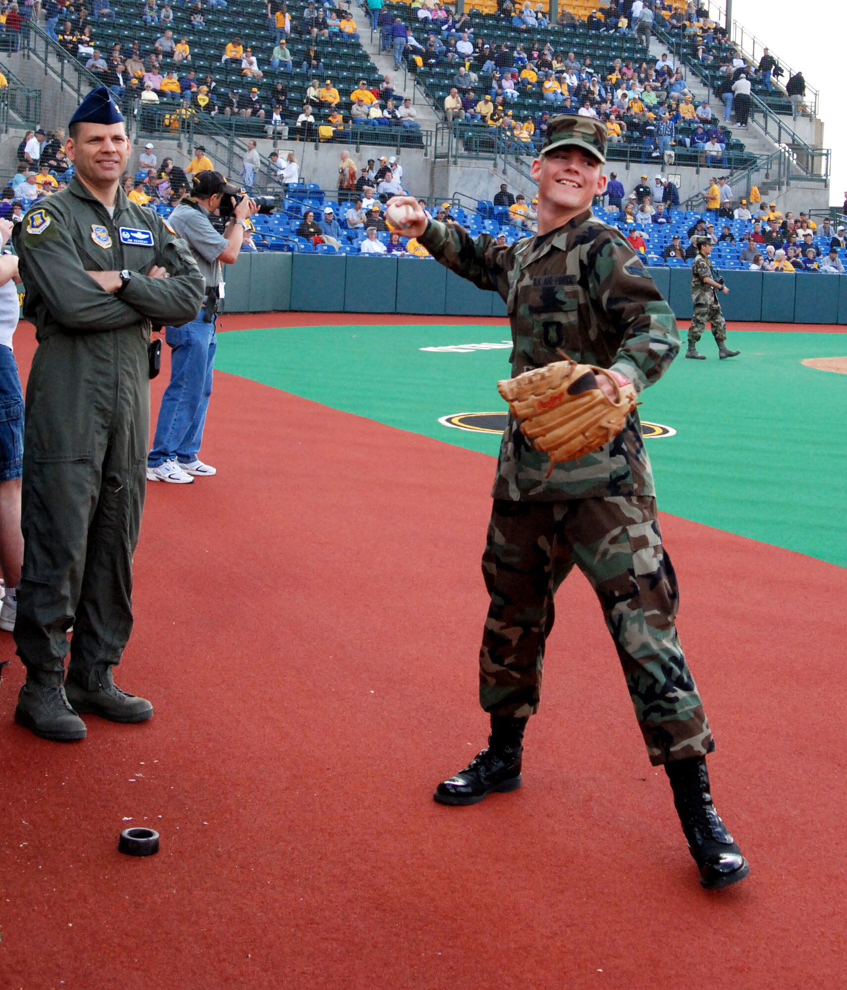 WICHITA, Kan. -- Col. James Vechery, 22nd Air Refueling Wing commander watches Airman 1st Class Michael Wark, 22nd Communication Squadron, throw a practice pitch before a Wichita State University Shocker’s base ball game at Wichita University’s Eck’s Stadium, April 29. The two McConnell members represented the military during the Military Appreciation Night where Airman Wark, one of McConnell’s newest Airmen, threw the game’s opening first pitch.  (Photo by Airman 1st Class Jessica Lockoski)