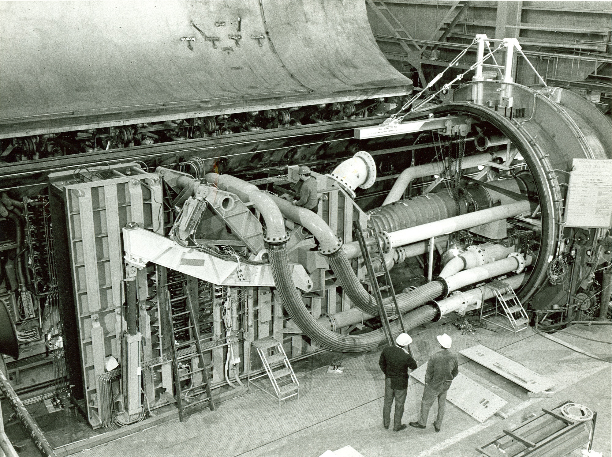 From left, Arnold Engineering Development Center, Arnold Air Force Base, Tenn., Project Engineer Bob Ansley and Marshall Seymour, center engineer, prepare for a checkout of the 36-ton jet engine inlet mechanism for simulating a jet engine inlet’s internal contour and ramps in the center’s T-1 altitude test cell in 1971. (File photo)