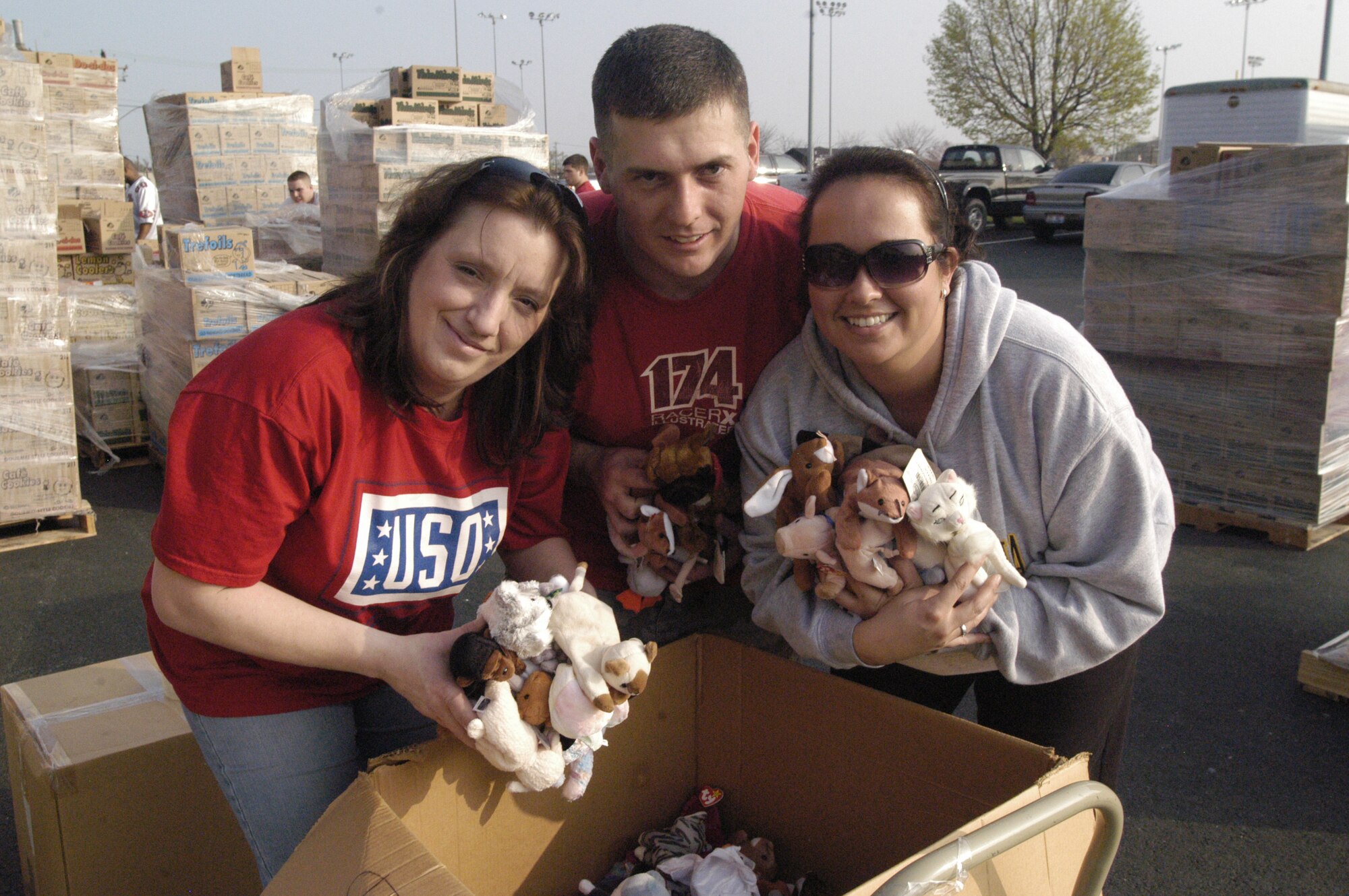 (Left to right) Petty Officer Angel Mace, wife of Tech. Sgt. Brian Mace, 436th Aircraft Maintenance Squadron, flying crew chief program manager, Tech. Sgt. Jimmy Heater, 436th Logistic Readiness Squadron chief dispatcher, and his wife Joanna Heater, pack Beanie Babies into a box. Team Dover members and their families came out to help sort, organize and package donated items to support USO Delaware. (U.S. Air Force photo/Airman 1st Class Shen-Chia Chu)