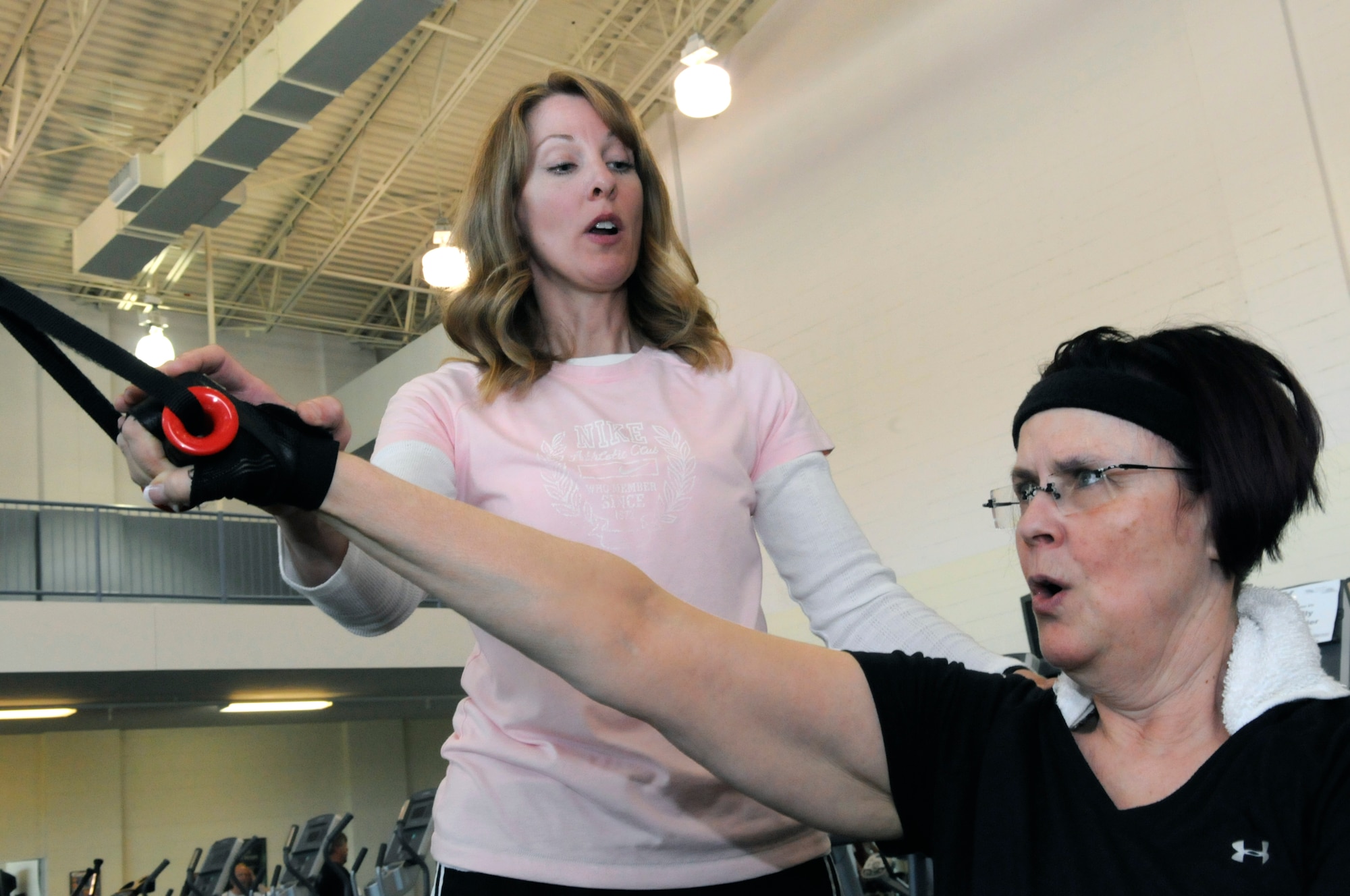 Kim Wilson, a contracted certified personal fitness trainer, works with Shirley Abbott Clark at Robins Fitness Center April 30. U. S. Air Force photo by Sue Sapp