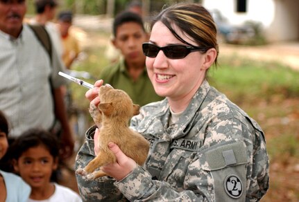 LAGUNA DEL RINCON, Honduras - Army Reserve Sgt. Mitzi L. Porter of the 993rd Medical Detachment (Veterinary Services) of Aurora, Colorado, administers de-worming medication to a puppy. Veterinarians, like Porter, provide basic medical and dental care to dogs, cats and livestock during daylong visits to this and other remote Honduran villages. U.S. military medical personnel are in Honduras for the joint training exercise Beyond the Horizon. The event provides medical attention, as well as infrastructure renovation, to rural areas in this Central American country. Photo by Sgt. Claude W. Flowers, 304th Public Affairs Detachment.