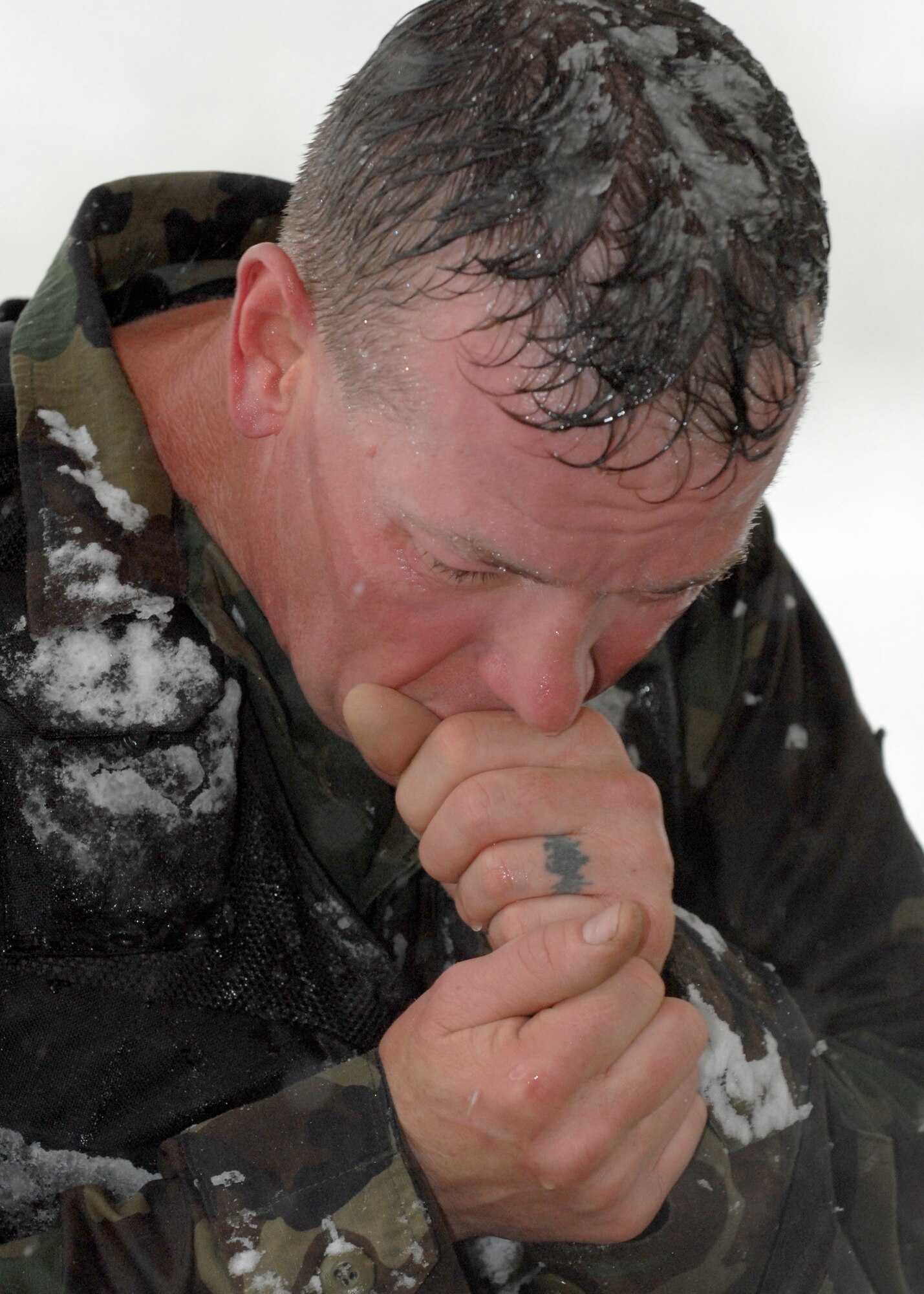 Tech. Sgt. Duane Blackmon, a member of Buckley’s Security Forces Guardian Challenge team, warms his hands during the endurance portion of the 2008 Guardian Challenge held at Peterson Air Force Base. (U.S. Air Force photo by Airman First Class Randi Flaugh)