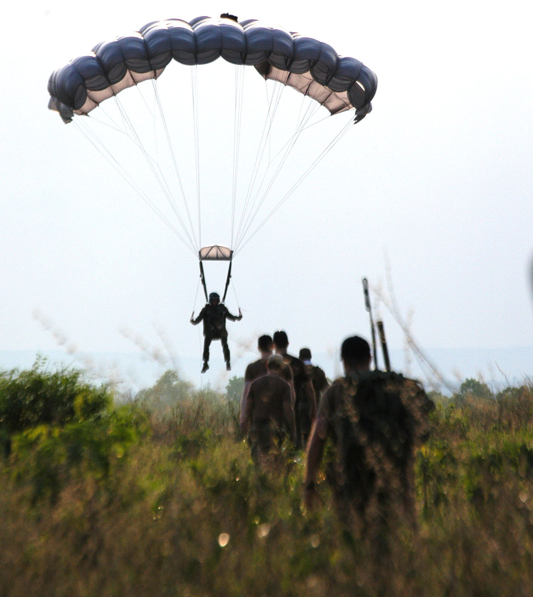 Drop zone controllers head out to recover a jumper from the 320th Special Tactics Squadron during Exercise Teak Torch. Jumpers from both the 353rd Special Operations Group and the Royal Thai Air Force completed daily "friendship jumps" as part of the joint combined exercise training. (U.S. Air Force photo/Master Sgt. Marilyn Holliday)                            