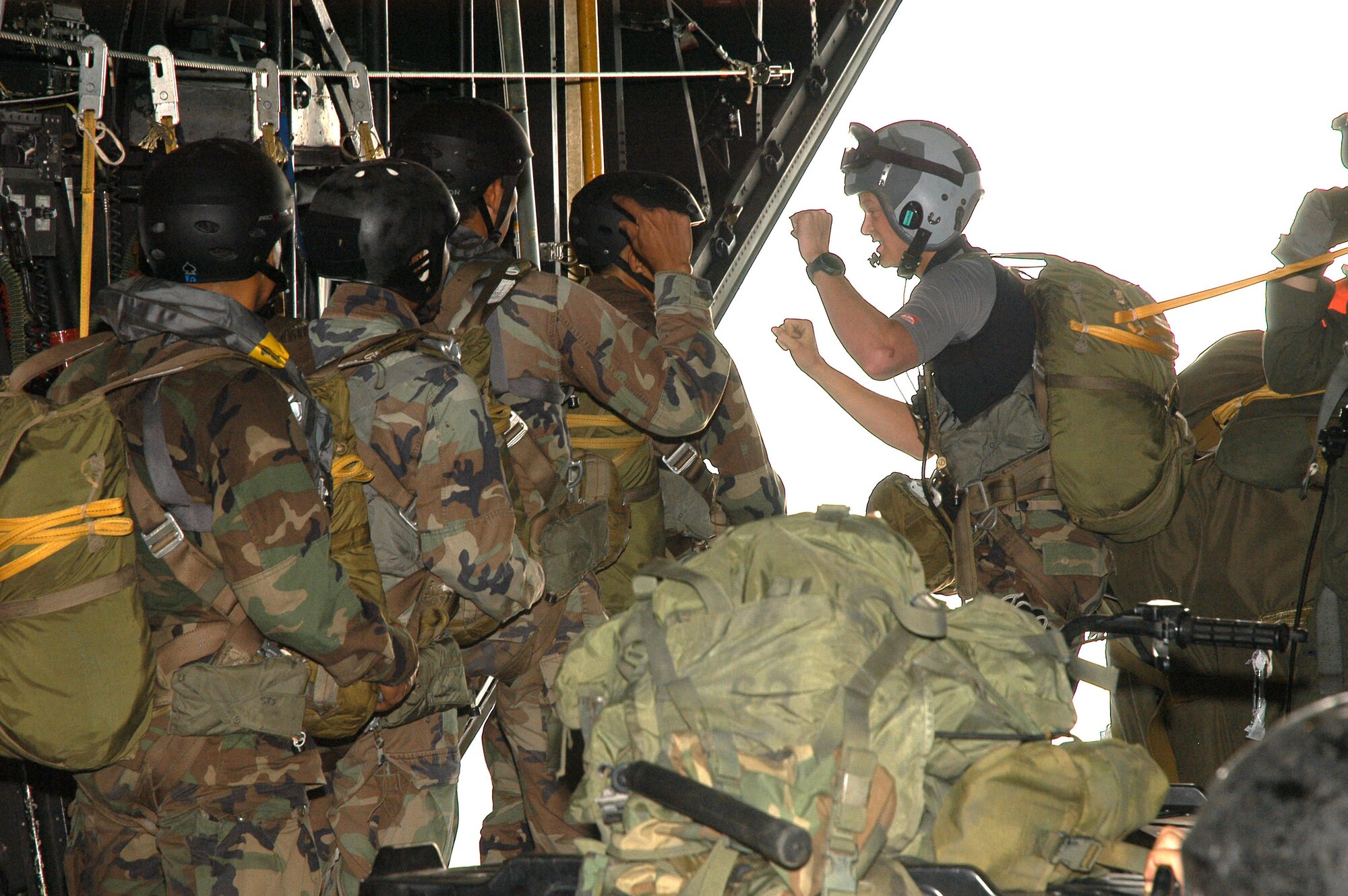 A combat controller from the 320th Special Tactics Squadron (right) gives the final count for a static line jump of Royal Thai Air Force special forces aboard an MC-130P Combat Shadow.  The American and Thai airmen were participating in Exercise Teak Torch. (U.S. Air Force photo/Master Sgt. Marilyn Holliday)             