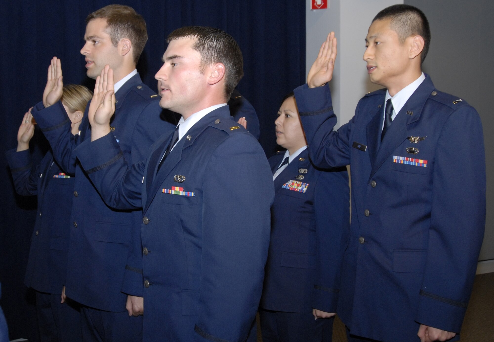 Lieutenants Paul Adams, Jonathan Walsh, Lynette Bates, and Yu Wei (left to right) receive the Oath of Office from Col. David Madden GPS wing commander, on Wednesday at the April Monthly Promotion and Recognition Ceremony. (Photo by Joe Juarez)
