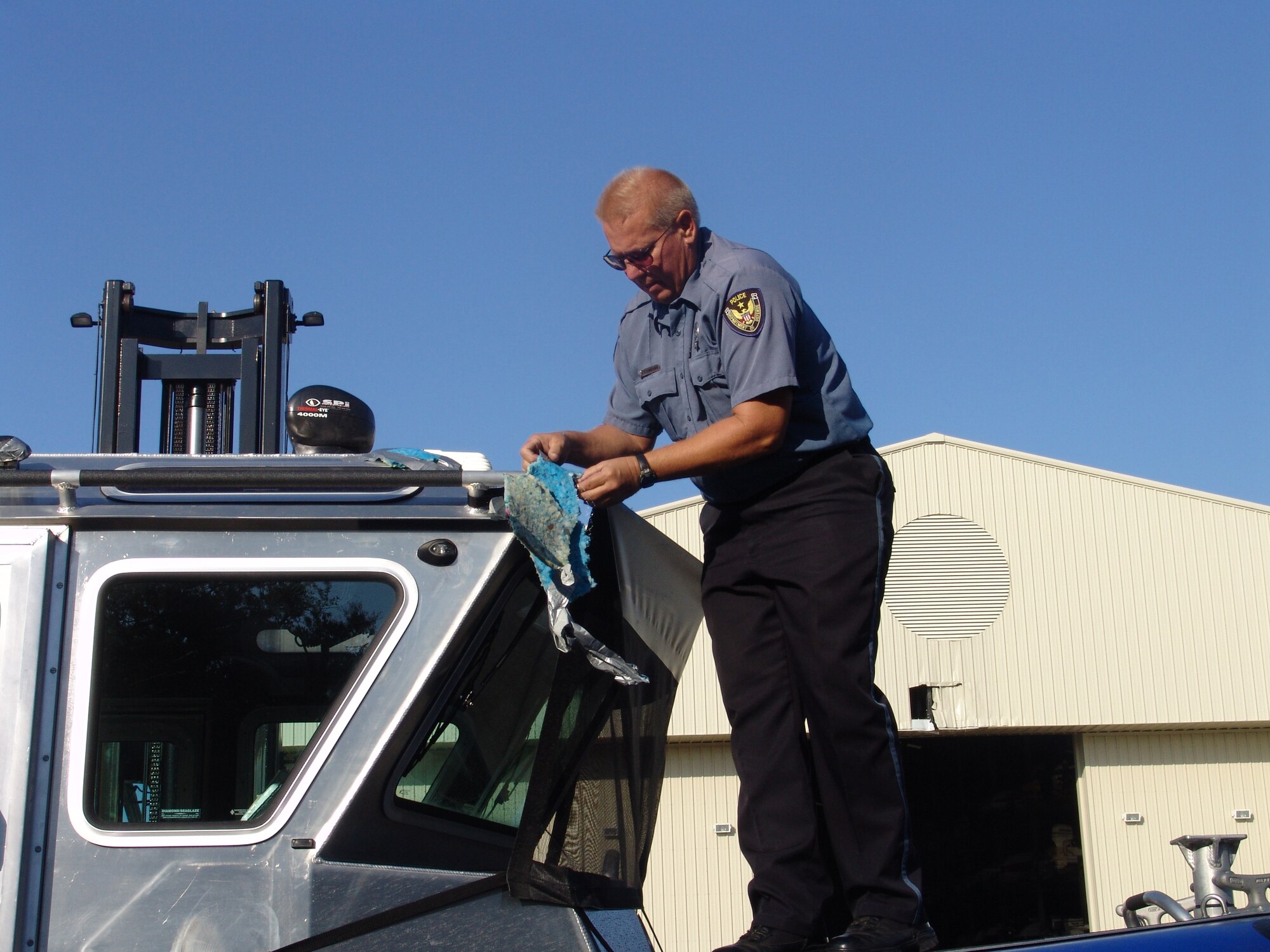 EGLIN AIR FORCE BASE, Fla. -- Mr. Kurt Rommendal, 96th Security Forces Squadron, unveils the squadron's latest weapon in force protection, a 25-foot patrol boat.  (USAF photo by Lois Walsh)   
