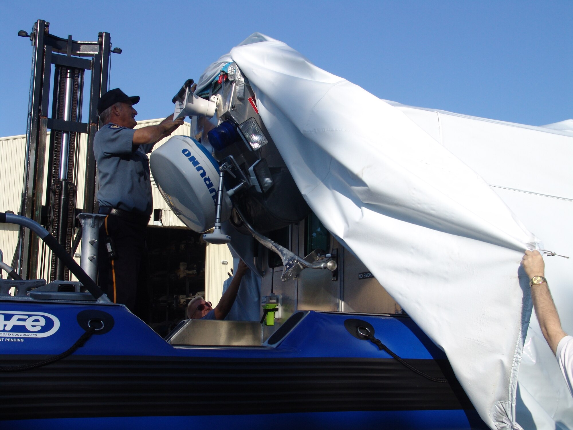 EGLIN AIR FORCE BASE, Fla. --Chief Jerry Brown, 96th Security Forces Squadron, unveils the squadron's latest weapon in force protection, a 25-foot patrol boat.  (USAF photo by Lois Walsh)                                  