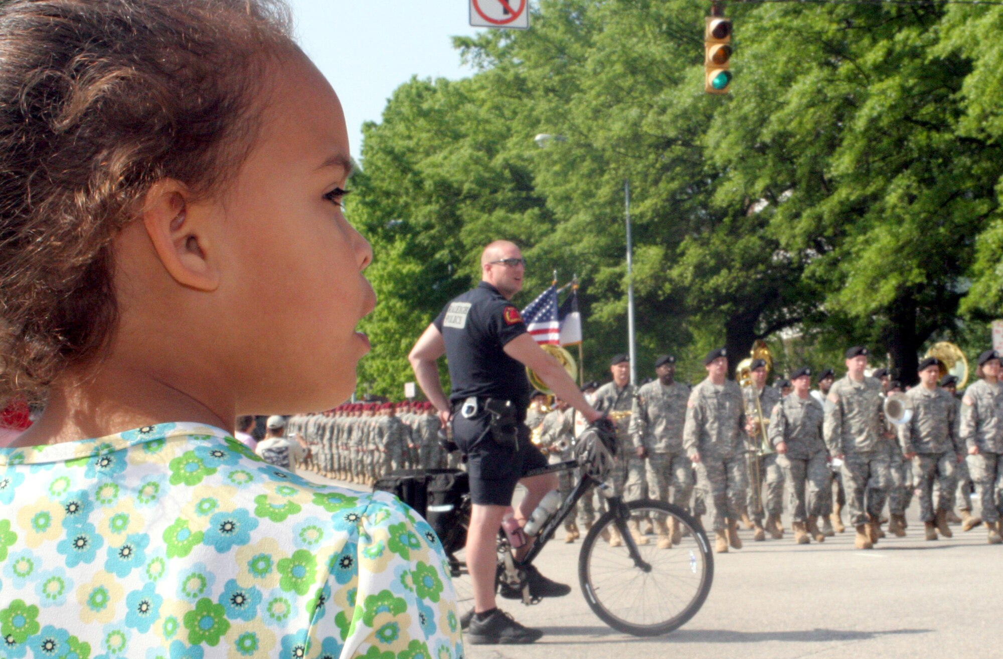 RALEIGH, N.C. - Three-year-old Zoey Stevenson watches the Salute the Troops parade in Raleigh April 26. The parade, opened by a four-ship flyover of F-15E Strike Eagles form Seymour Johnson AFB, featured every branch of the active-duty military, the National Guard, Air Guard and Coast Guard, from every installation in the state and more than 50,000 spectators attended. Zoey?s mother is an Airmen at Seymour Johnson AFB and her father is a Marine at Camp LeJeune MCB. (U.S. Air Force photo by Capt. Tana R.H. Stevenson)