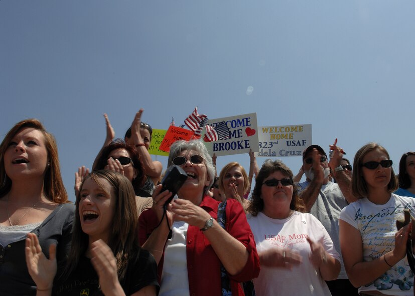 MOODY AIR FORCE BASE, Ga. -- Family members, friends and co-workers cheer here April 29 as Airmen of the 823rd Security Forces Squadron return from a six-month deployment to Camp Bucca, Iraq. All Airmen and military working dogs returned home safely. (U.S. Air Force photo by Airman 1st Class Brittany Barker)