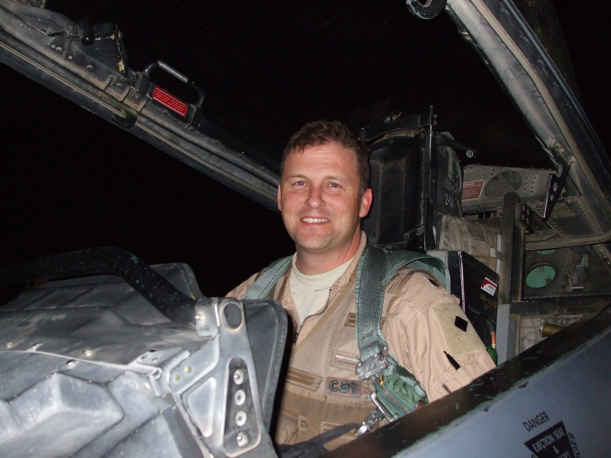 BAGRAM AIR FIELD, Afghanistan – Lt. Col. Travis “Flak” Willis, an F-15E Strike Eagle weapon systems officer, sits in his ‘office’ after returning from a milestone mission here.  Colonel Willis reached 1,000 combat hours March 31 while flying his 335th mission while deployed with the 335th Expeditionary Fighter Squadron.  (Courtesy Photo)