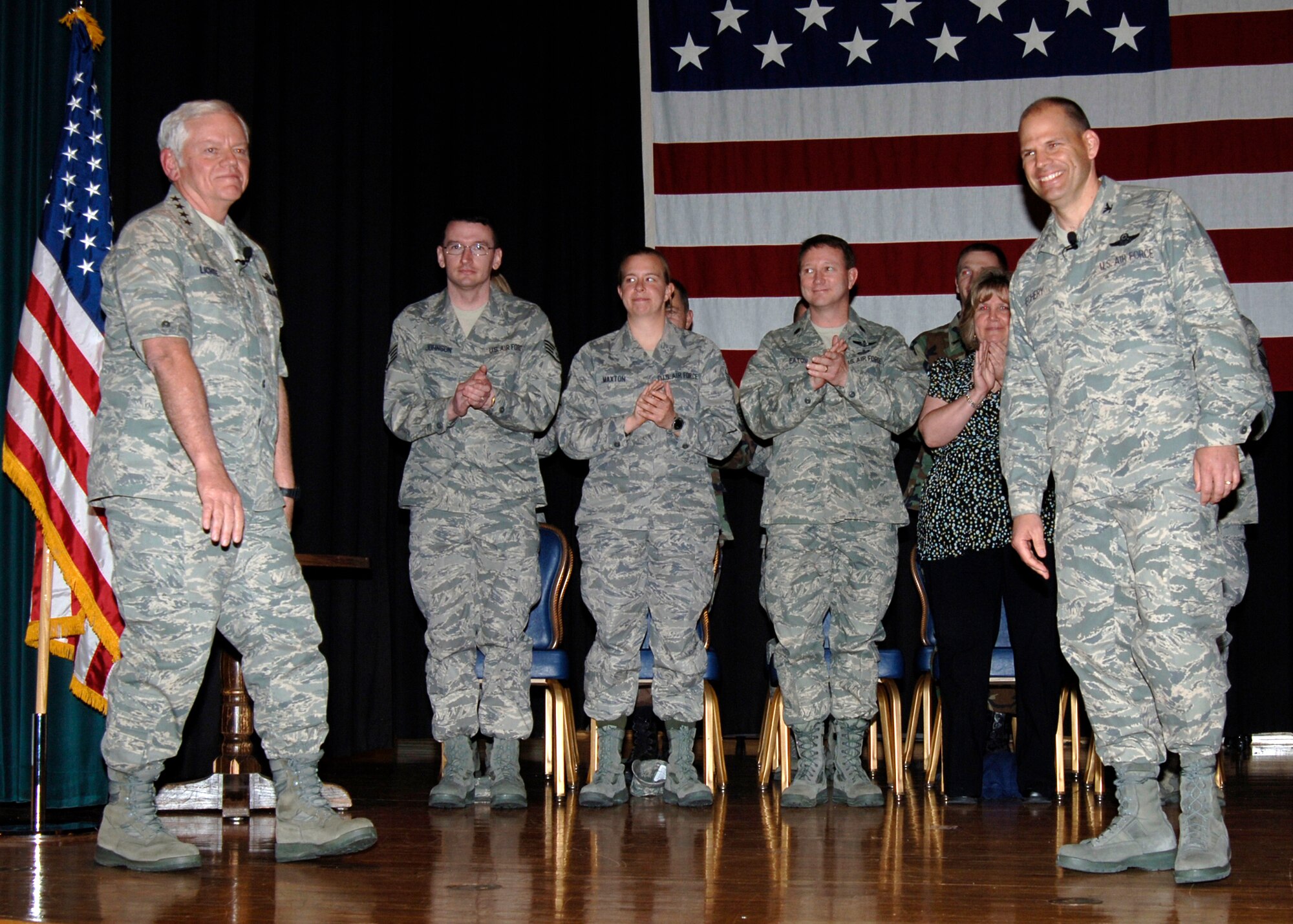 Three members of the 931st Air Refueling Group Intelligence Directorate join in applause during an awards gathering at McConnell Air Force Base in April.  The gathering was organized during a three-day visit to McConnell by Gen. Arthur Lichte(far left), Air Mobility Command commander, Scott Air Force Base, Ill.  The 931st troops were invited to the gathering after being named AMC's Outstanding Air Reserve Component Intelligence Unit of the Year. Attending were (from left to right) Staff Sgt. Joseph Johnson, Tech. Sgt. Crystal Maxton, and the directorate's commander, Lt. Col William Eaton.  Also out front is Col. James Vechery (far right), 22nd Air Refueling Wing Commander.
