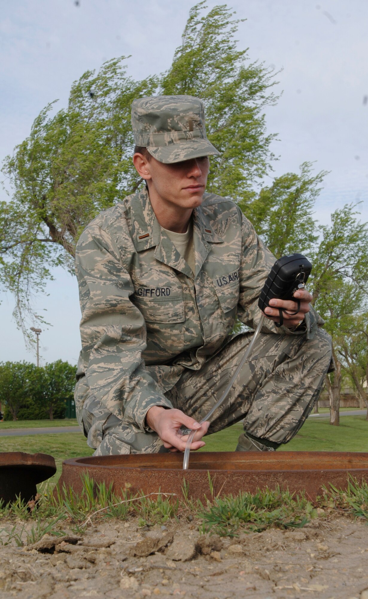 MCCONNELL AIR FORCE BASE, Kan. -- 2nd Lt. Michael Gifford, 22nd Aerospace Medicine Squadron, is testing a sewer with an Entry Rae at the clinic, April 29. Entry Rae is used for detection of harmful gases before entering an area, usually in small spaces.  (Photo by Senior Airman Roy Lynch III)