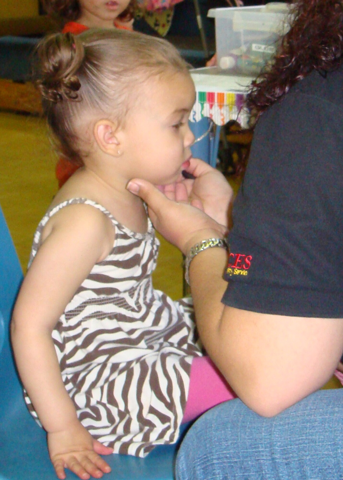 Ava Gatewood sits as still as she can while getting her face painted at the Military Child Fair April 26 at RAF Lakenheath, England. Liberty Airmen and their families were invited to celebrate military children during the fair at the Lakenheath Youth Center. Activites included face painting, a rock wall, bouncy castles and arts and crafts. (U.S. Air Force photo by Airman 1st Class Torri Ingalsbe)