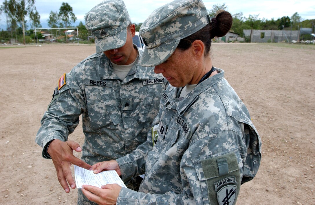 LA MERCED, HON - Sgt. Jose Reyes discusses contractor payments with Cpt. Rachelle Hathaway, both are from the 478th Civil Affairs Batallion, Miami and serve as the primary coordination interface between U.S. military forces and the civil sector. They arrange contracts between local vendors and the Beyond the Horizon contractor pay office, as well as facilitate engagement activities with the local populace and BTH. Photo by Staff Sgt. Danny McCormick, Beyond the Horizon Public Affairs Office.