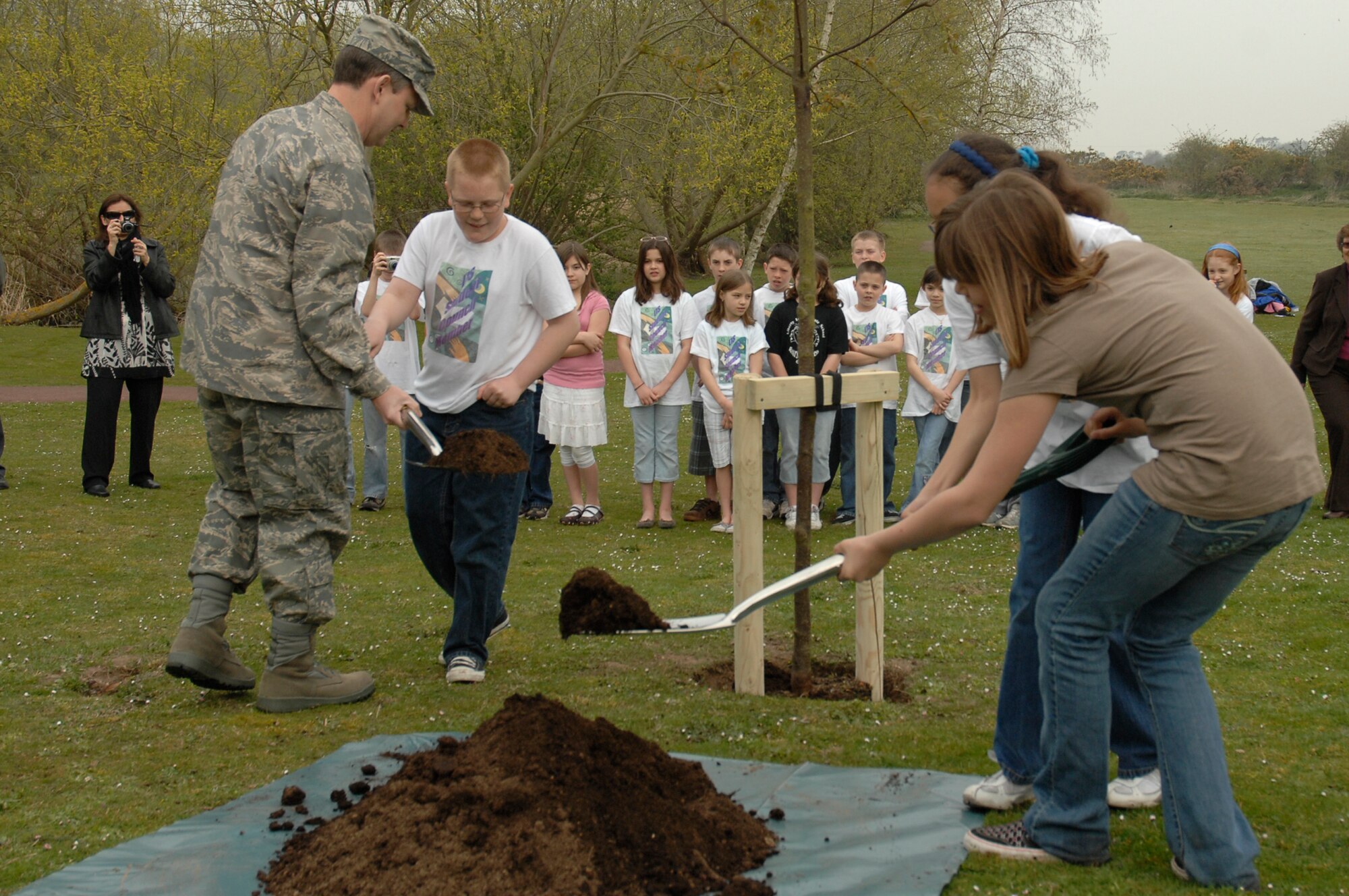 Brig. Gen. John Hesterman, 48th Fighter Wing commander, assists Haden Olson, a fifth grader at Lakenheath Intermediate School, plant a British Bird Cherry tree in honor of Earth Week, April 23 at RAF Lakenheath, England. "Small Changes--Big Differences" is RAF Lakenheath and RAF Mildenhall's motto for Earth Week which runs until April 26. (U.S. Air Force photo by Airman 1st Class Erika Brooke)
