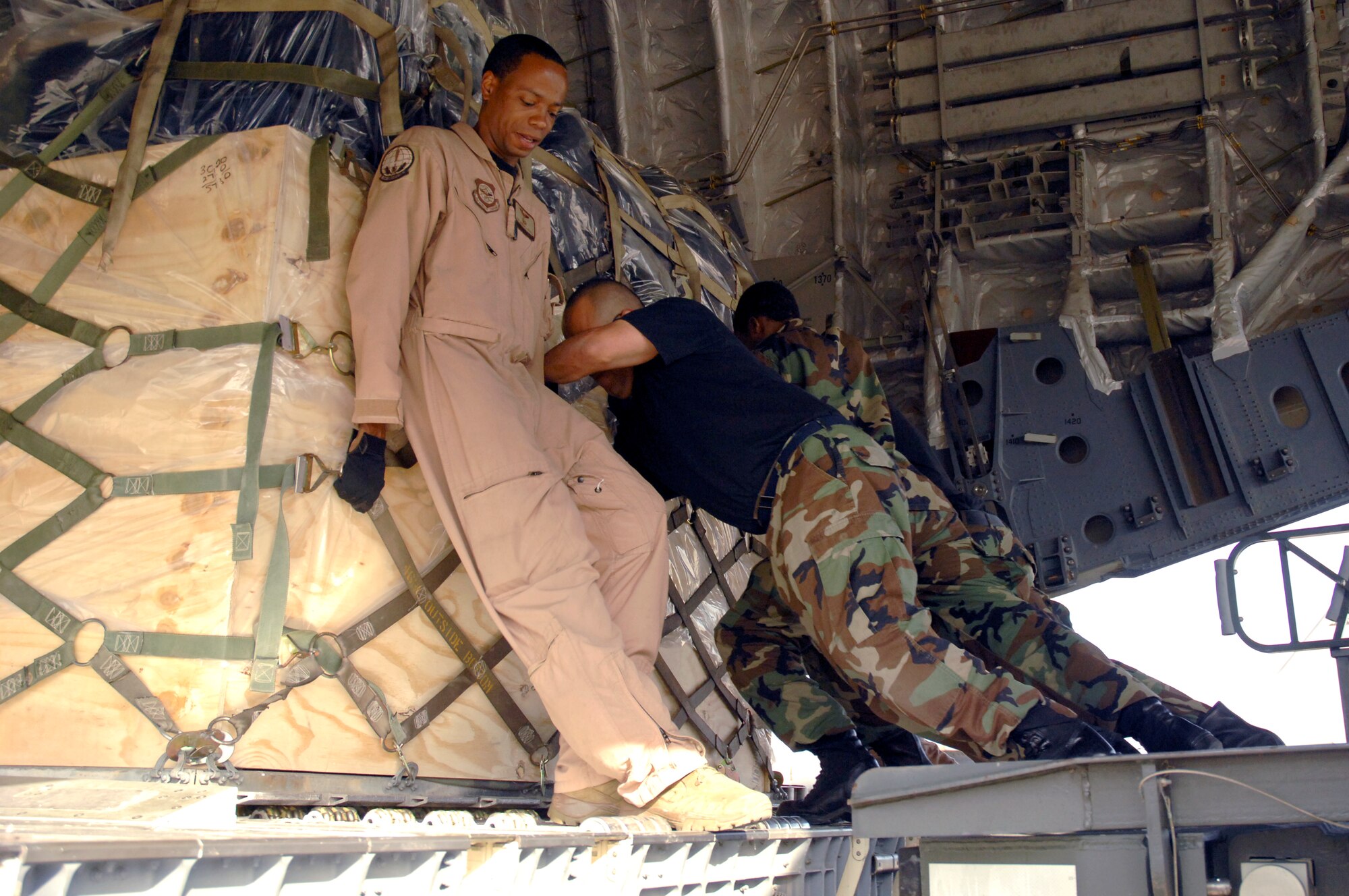 Tech. Sgt. Derrick Russell, and 48th Logistics Readiness Squadron Airmen load cargo into a C-17 Globemaster III April 26 at RAF Lakenheath, England. More than 400 Airmen deployed in support of Operations Iraqi and Enduring Freedom. (U.S. Air Force photo by Airman Perry Aston)