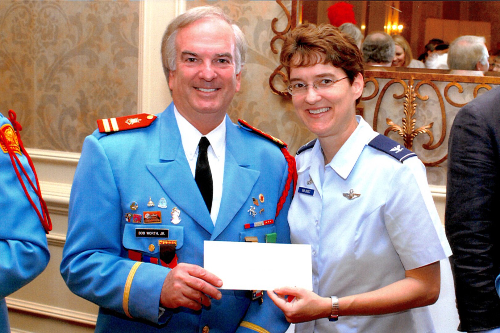 Col. Jacqueline Van Ovost, 12th Flying Training Wing commander, accepts a $5,000 grant from Bob Worth, Jr., an official from the Texas Cavaliers Foundation, for the "Friends of the Family Support Center" fund during a Fiesta 2008 celebration April 21. (U.S. Air Force photo by Don Lindsey)