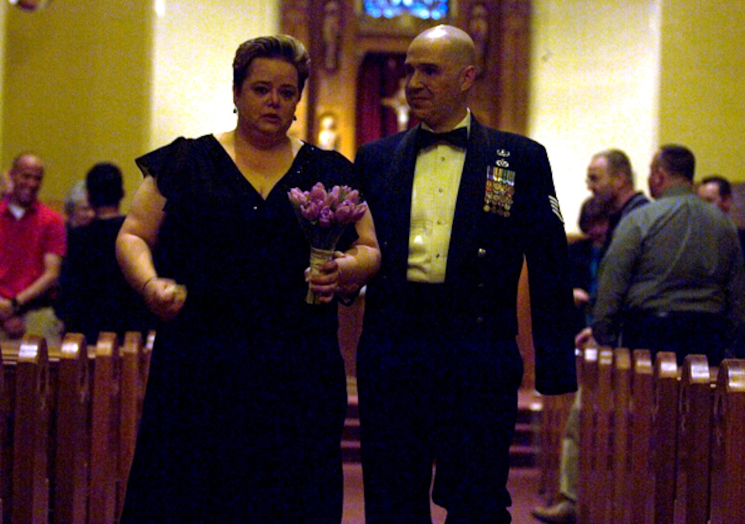 Annette and Staff Sgt. Matthew Slaydon walk down the aisle after renewing their vows at the base chapel. (Photo by Tech. Sgt. Matt Hannen)