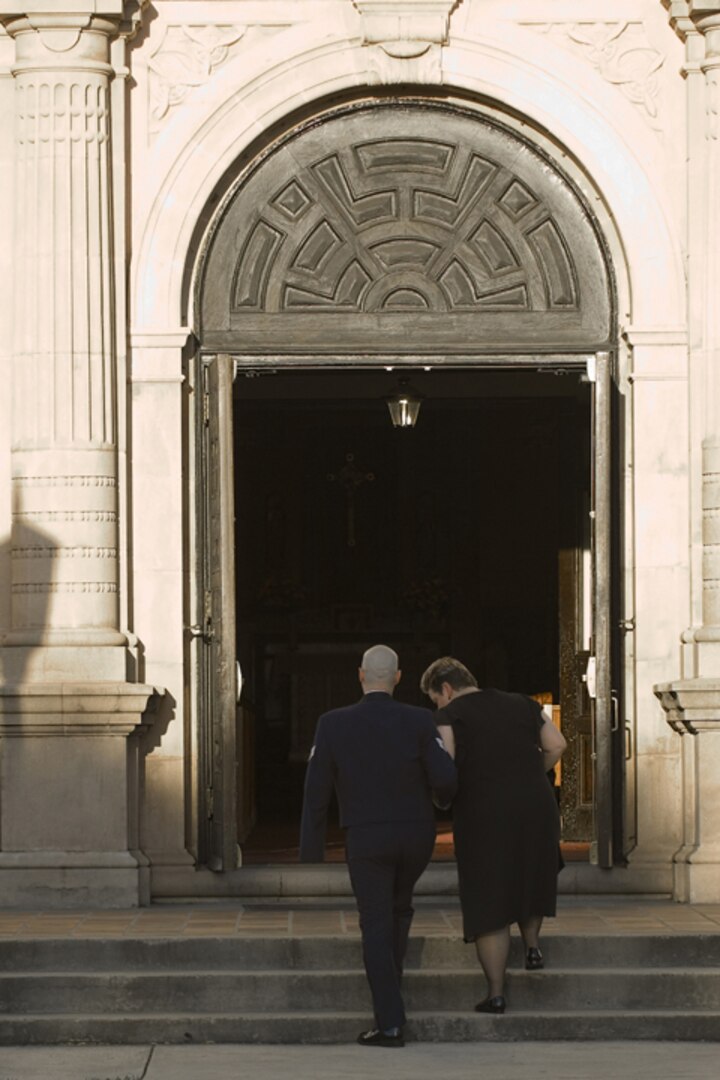 Annette and Staff Sgt. Matthew Slaydon walk up the stairs to their vows at the base chapel. (Photo by Tech. Sgt. Matt Hannen)