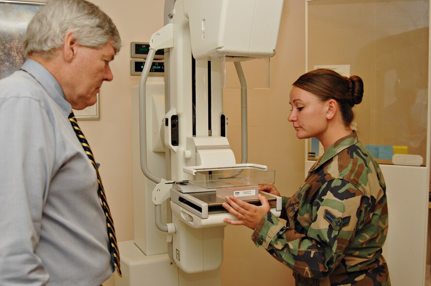 Mr. Terry Bolen of the Food and Drug Administration observes Airman 1st Class Katherine Ferguson, 39th Medical Support Squadron, set up a "phantom" breast tissue on a mammography machine during an inspection of the 39th Medical Group mammography department April 21. The "phantom" breast tissue has the consistency of real breast tissue with fibers, spectrobes and various masses of cancer inside. Once the image of the phantom tissue is taken, it must meet a minimum score to verify the machine is capable of detecting those masses in the phantom tissue. (U.S. Air Force photo by Senior Airman Lauren Padden)