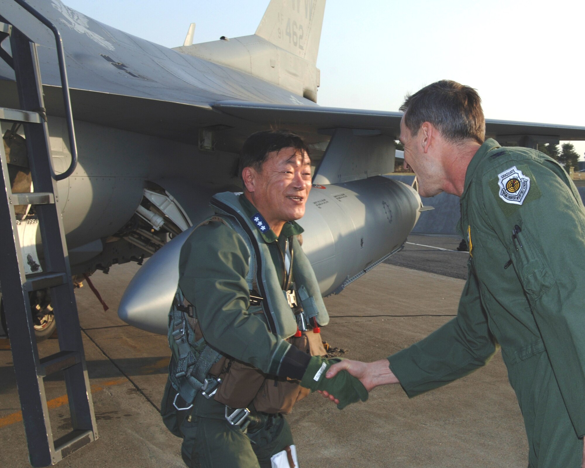 MISAWA AIR BASE, Japan -- Lt. Gen. Shigeru Irizawa, Northern Air Defense Force commander, is greeted by Col. T.J. O'Shaughnessy, 35th Fighter Wing commander, after a familiarization flight in the F-16 Fighting Falcon on April 15, 2008. General Irizawa was provided the flight as an opportunity to familiarize himself with the aircraft and the 35th FW mission. (U.S. Air Force photo by Senior Airman Robert Barnett)
