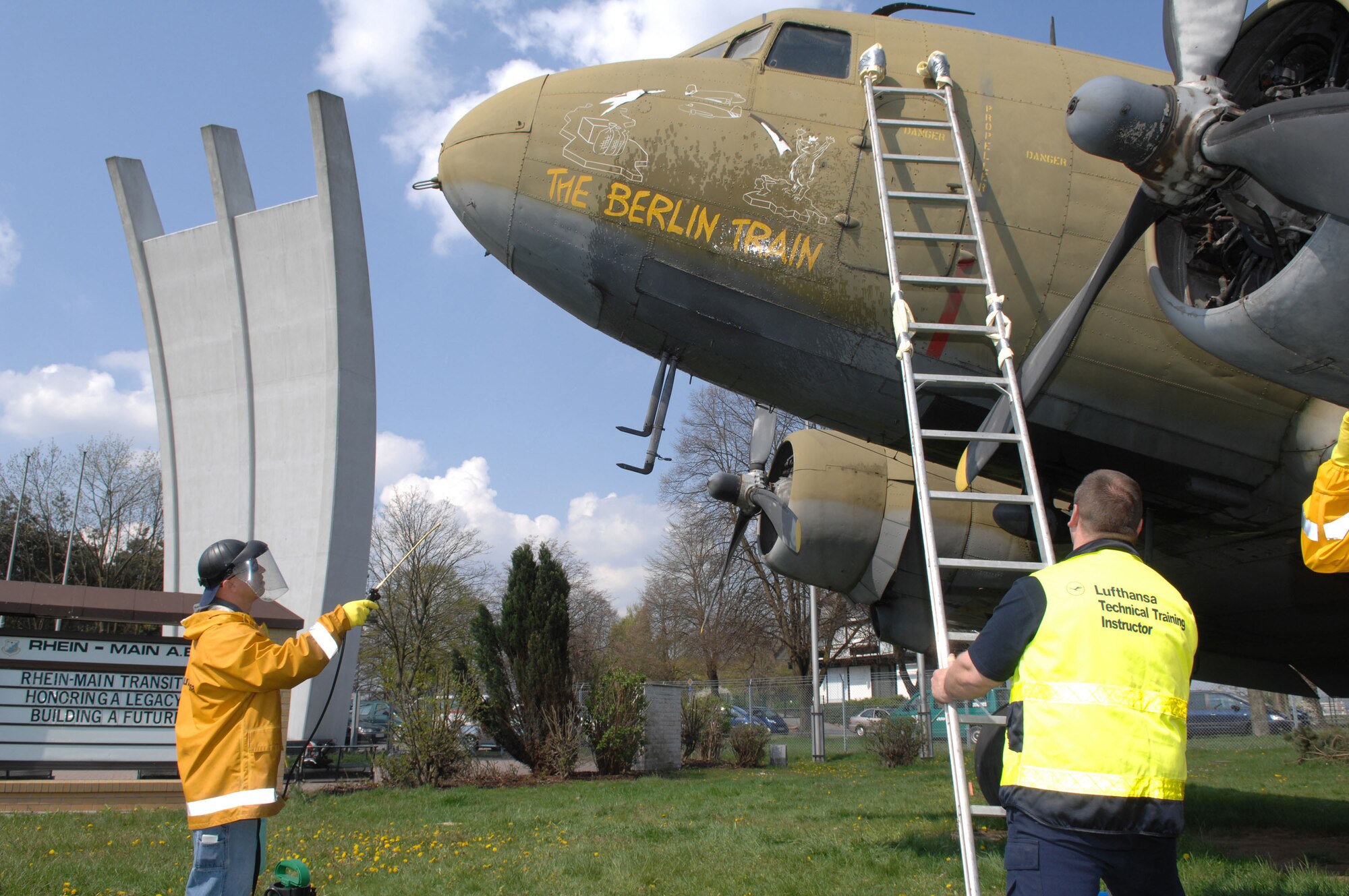 Air Force Staff Sgt. Kevin Cloyd, an aircraft maintenance crew chief, rinses the nose art on a static C-54 on display at the Berlin Airlift Memorial site of the former Rhein Main Air Base near Frankfurt International Airport in Germany. Cloyd and a team of approximately 30 volunteers from Ramstein Air Base spent three days cleaning the display aircraft for refurbishing in prepartion for a Berlin Airlift 60th Anniversary Celebration to take place there in June. (Department of Defense photo by Air Force Tech. Sgt. Corey Clements) 