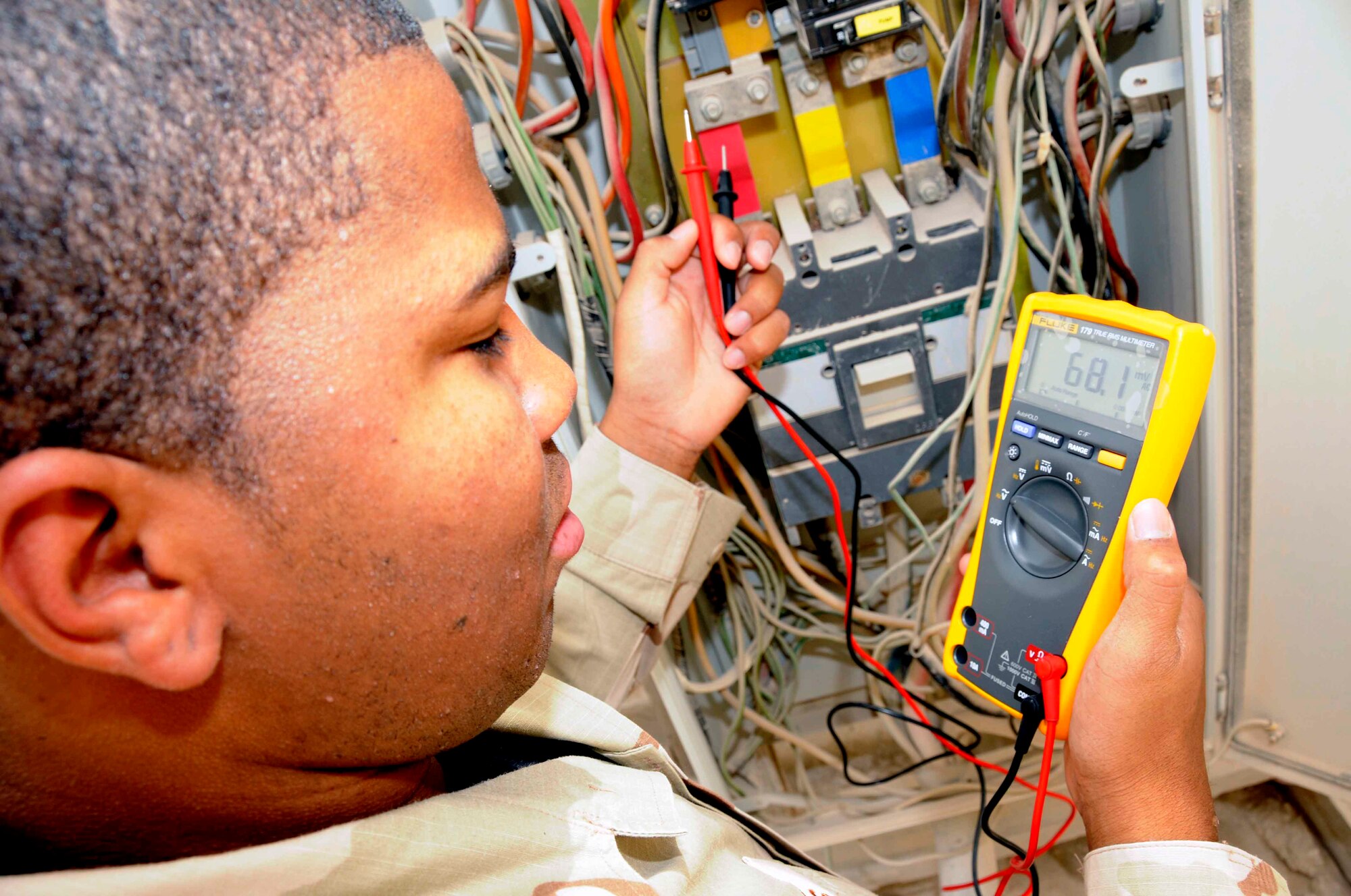 SOUTHWEST ASIA—Airman 1st Class Brian Sanders, 379th Expeditionary Civil Engineer Squadron electric shop, conducts a meter reading on a distribution panel April 30. Meter readings are performed when checking for power that might be lacking in certain wires, and other quality assurance discrepancies. (U.S. Air Force photo/ Senior Airman Domonique Simmons)