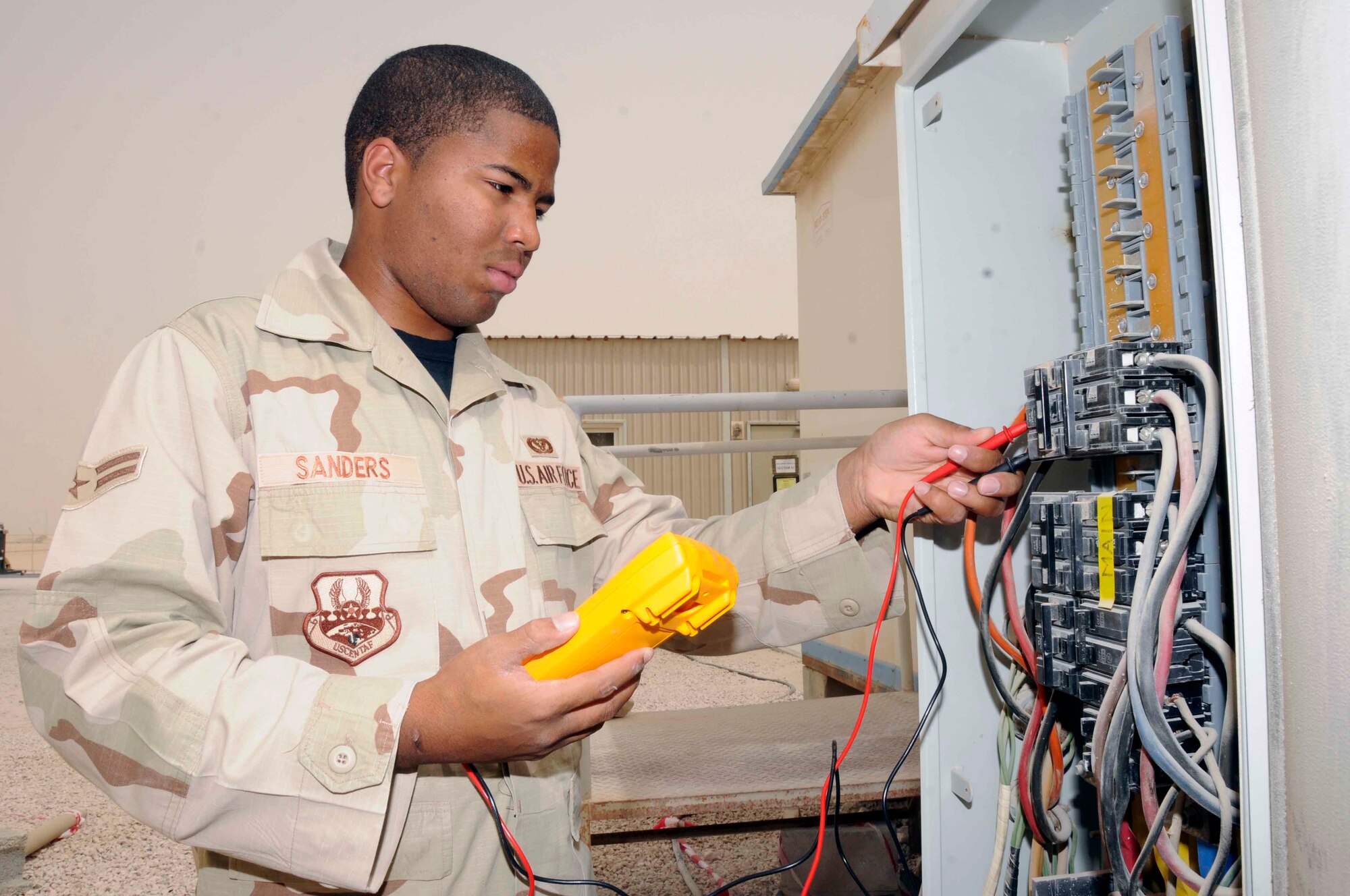 SOUTHWEST ASIA—Airman 1st Class Brian Sanders, 379th Expeditionary Civil Engineer Squadron electric shop, conducts a meter reading on a distribution panel April 30. Meter readings are performed when checking for power that might be lacking in certain wires, and other quality assurance discrepancies. (U.S. Air Force photo/ Senior Airman Domonique Simmons)