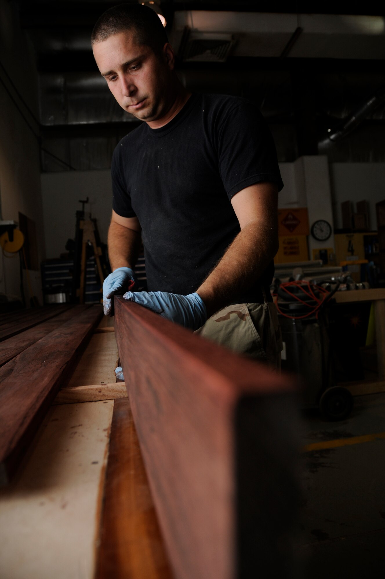 SOUTHWEST ASIA—Staff Sgt. Raymond Johnson, 379th Expeditionary Civil Engineer Squadron sructures shop, works on the trim for the new Wing Operations Center building April 30. Structures' daily workload can include anything from welding to carpentry and painting. (U.S. Air Force photo/ Senior Airman Domonique Simmons)