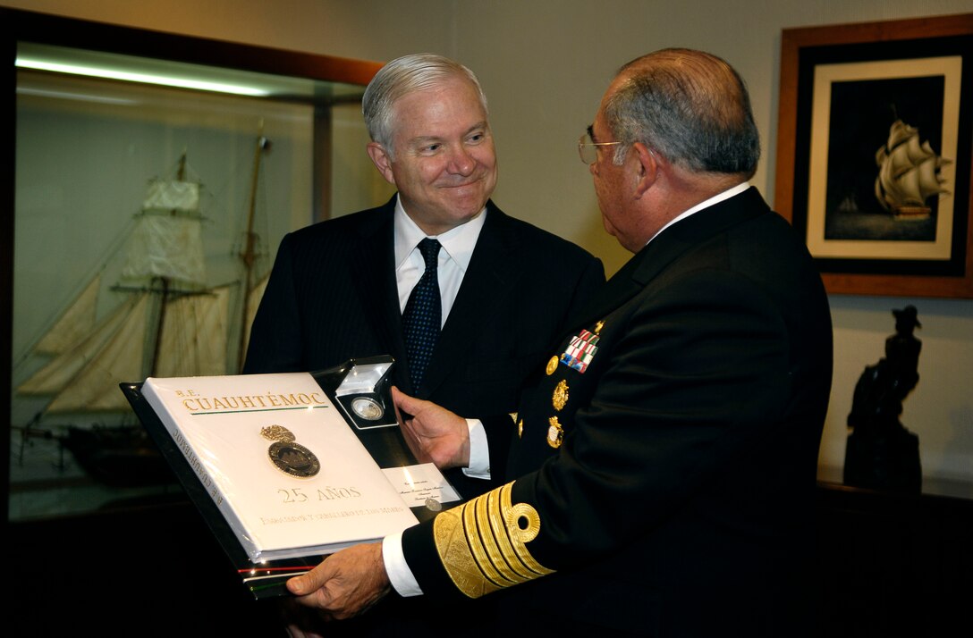 Mexican Navy Secretary Adm. Mariano Saynez presents a gift to Defense Secretary Robert M. Gates at the navy headquarters in Mexico City, April 30, 2008.  