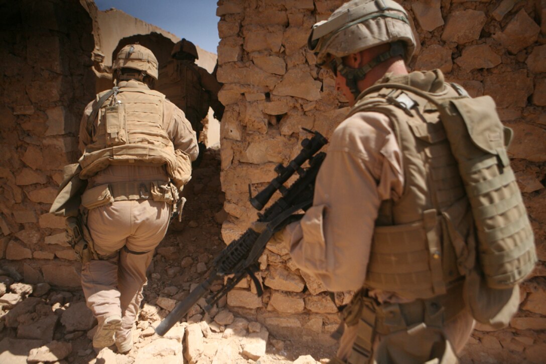 Marines with Charlie Company, 2nd Light Armored Reconnaissance Battalion, Regimental Combat Team 5 ensure the area is clear of threats during a cache search in western Anbar province May 1. The Marines with Charlie Company have found several caches around the area, including one with more than six 120 mm rounds the day before.