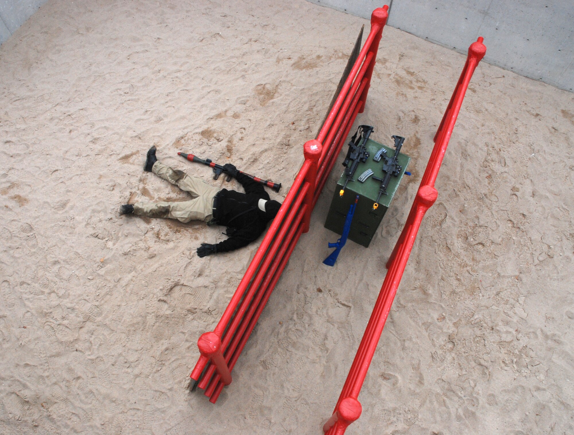 A simulated enemy combatant lies dead after succumbing to fake gunshot wounds inflicted by the joint 21st/721st Security Forces Squadron Guardian Challenge team May 2 at the U.S. Air Force Academy, Colo. The team competed against others throughout Air Force Space Command to determine which is the “best of the best” in defending installations and space assets world-wide. The six-man team is comprised of Tech. Sgt. Cesar Ochoa, Staff Sgts. Jordan Freeman, Brian Marshall and Jeffrey Turner, Senior Airman Eric Frias and Airman Stacy John. (U.S. Air Force photo/Senior Airman Stephen Collier)