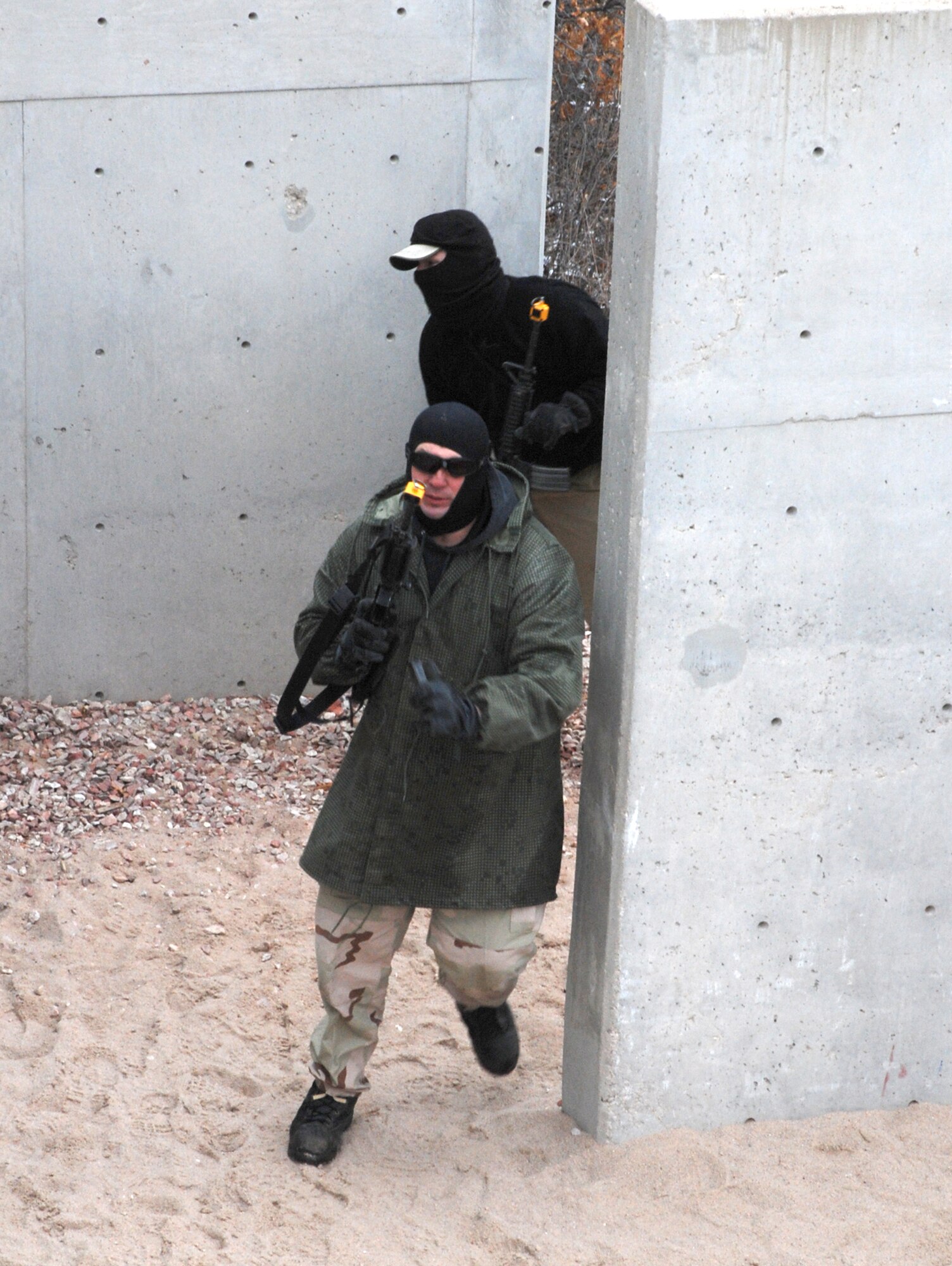 Simulated enemy combatants enter their stronghold as the joint 21st/721st Security Forces Squadron Guardian Challenge team is in pursuit May 2 at the U.S. Air Force Academy, Colo. The team competed against others throughout Air Force Space Command to determine which is the “best of the best” in defending installations and space assets world-wide. The six-man team is comprised of Tech. Sgt. Cesar Ochoa, Staff Sgts. Jordan Freeman, Brian Marshall and Jeffrey Turner, Senior Airman Eric Frias and Airman Stacy John. (U.S. Air Force photo/Senior Airman Stephen Collier)