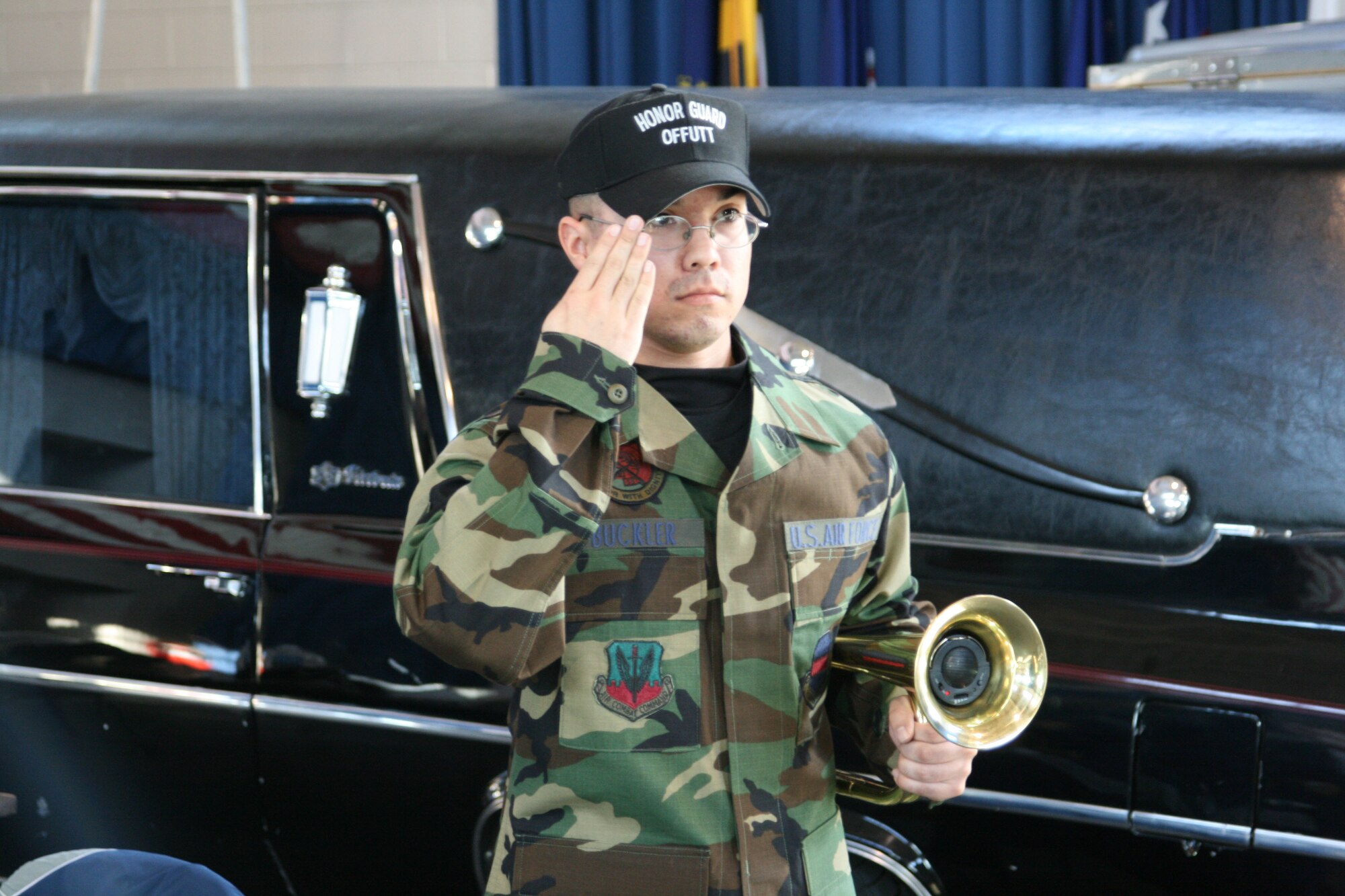 Airman 1st Class Charles Buckler, Offutt Honor Guardsman, renders a salute to the passing casket as part of military funeral honors. (Courtesy Photo)