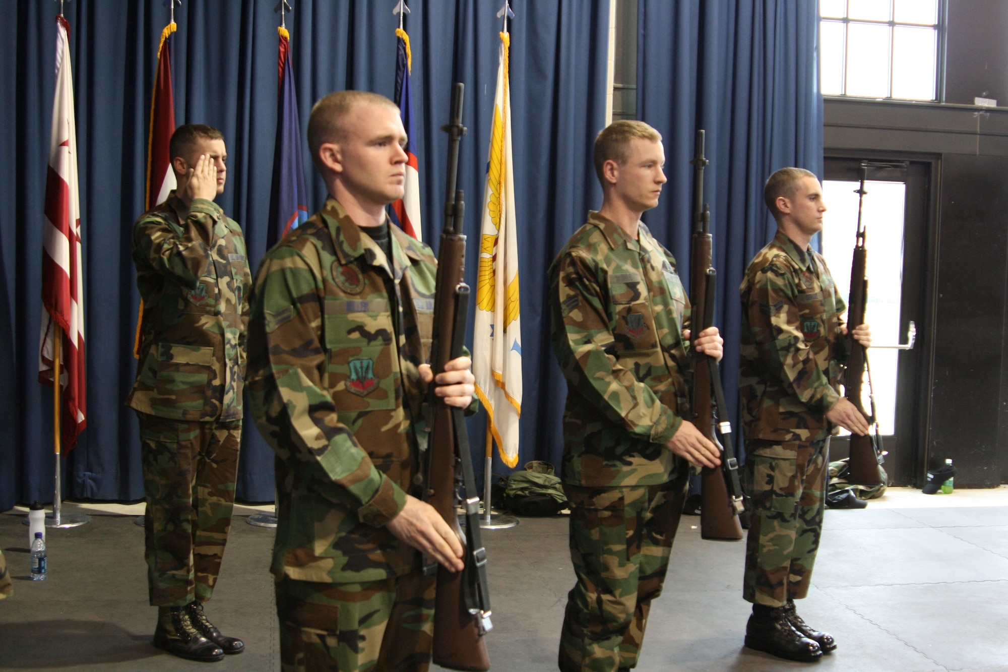 Then Airman 1st Class Patrick Miller (right), Senior Airman Stanley Munro and Airman 1st Class Austin DeRose, Offutt Honor Guardsmen, present arms as Airman 1st Class John Haszlauer, Offutt guardsman, salutes. Learning firing party is one of the three main areas of military funeral honors. (Courtesy Photo)