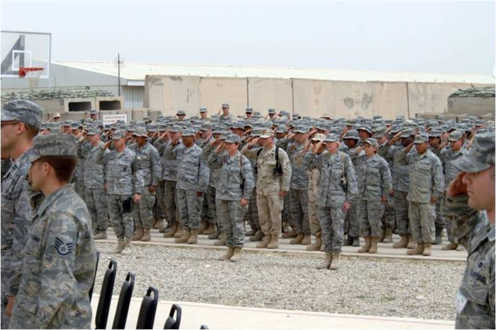 KIRKUK REGIONAL AIR BASE, Iraq -- Col. Richard Scobee accepts command of the 506th Air Expeditionary Group from Brig. Gen. Burton Field, 332nd Air Expeditionary Wing commander, April 30, here. Colonel Scobee is the 944th Fighter Wing commander, Luke Air Force Base, Ariz. (U.S. Air Force photo/Senior Airman SerMae Lampkin)