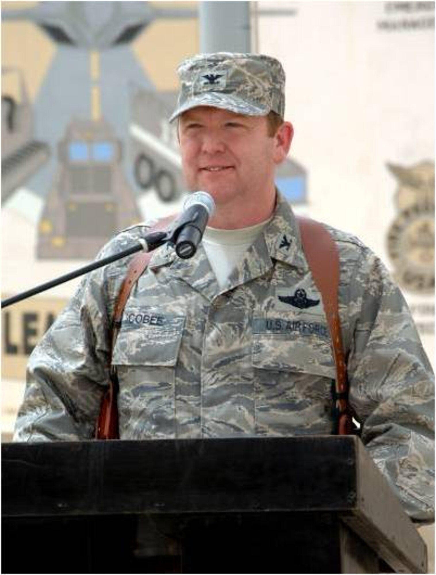KIRKUK REGIONAL AIR BASE, Iraq -- Col. Richard Scobee accepts command of the 506th Air Expeditionary Group from Brig. Gen. Burton Field, 332nd Air Expeditionary Wing commander, April 30, here. Colonel Scobee is the 944th Fighter Wing commander, Luke Air Force Base, Ariz. (U.S. Air Force photo/Senior Airman SerMae Lampkin)