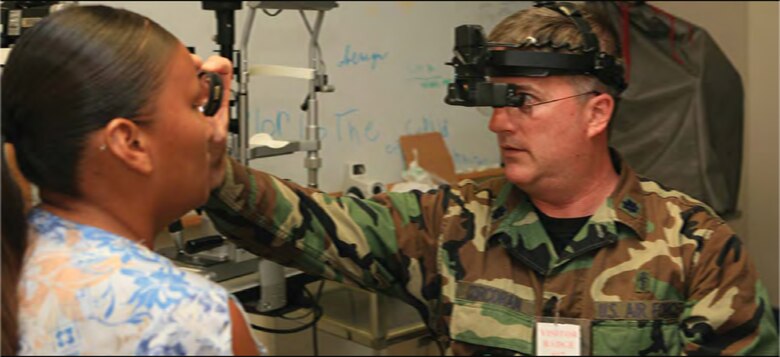 Air Force Lt. Col. Robert Corcoran, an optometrist with the 175th Medical Group, evaluates a patient at the Rosebud Comprehensive Health Care Facility in Rosebud, S.D.