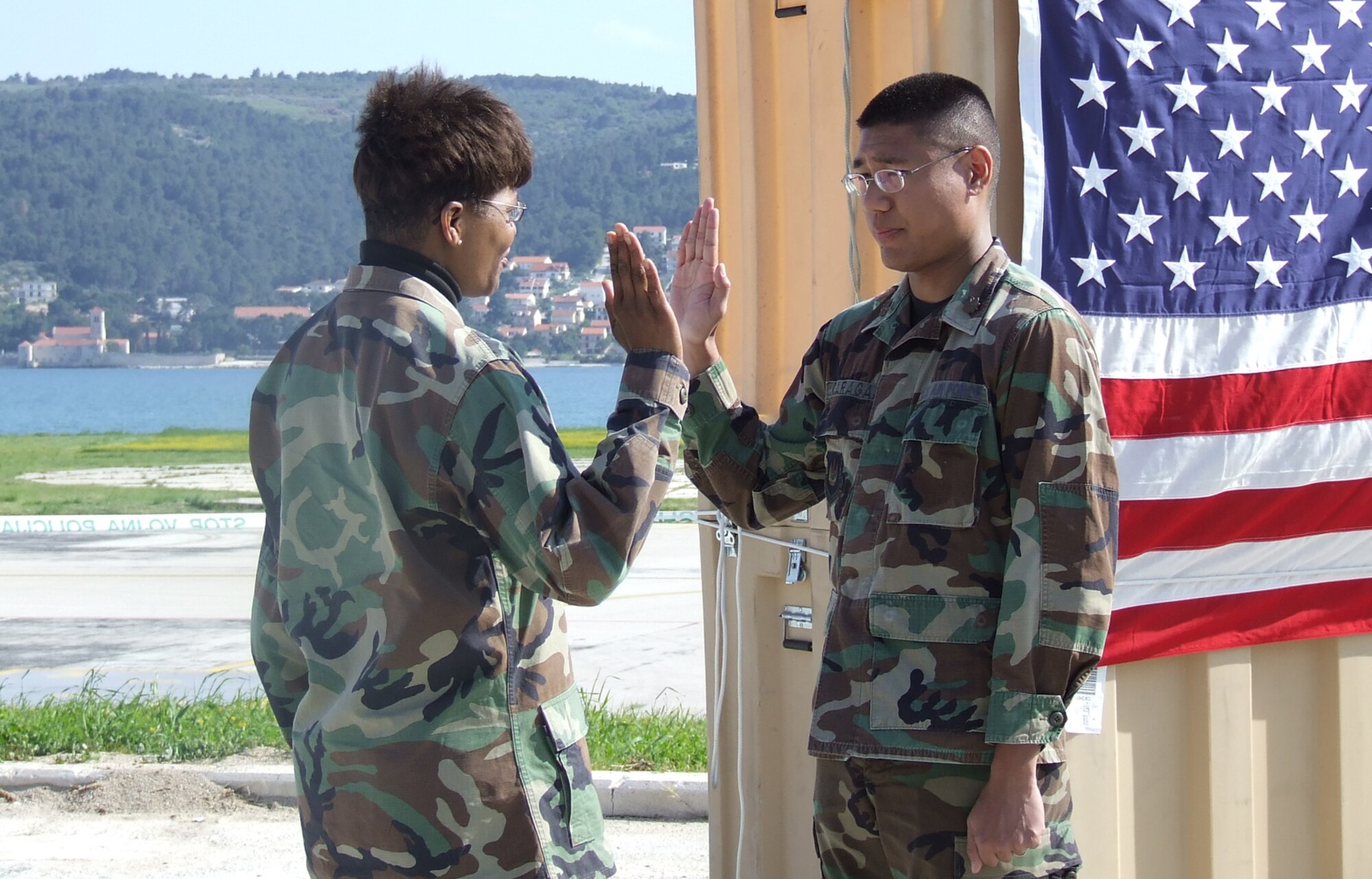DIVULJE TRAINING BASE, Croatia – Maj. Christopher Caragan repeats the Oath of Office given by Col. Angela Thompson during his promotion ceremony April 30. The U.S. Air Force Airmen are deployed to the 458th Expeditionary Medical Squadron from Ramstein Air Base, Germany, to participate in Medical Training Exercise in Central and Eastern Europe 2008 (MEDCEUR 08). Fifteen nations are participating in the exercise May 2 through 14. The exercise focuses on mass-casualty training scenarios and humanitarian aid in response to crises situations. More than 400 multi-nationals are attending the exercise in support of the Partnership for Peace initiative. (U.S. Air Force photo/Chaplain (Capt.) Gabriel Rios)