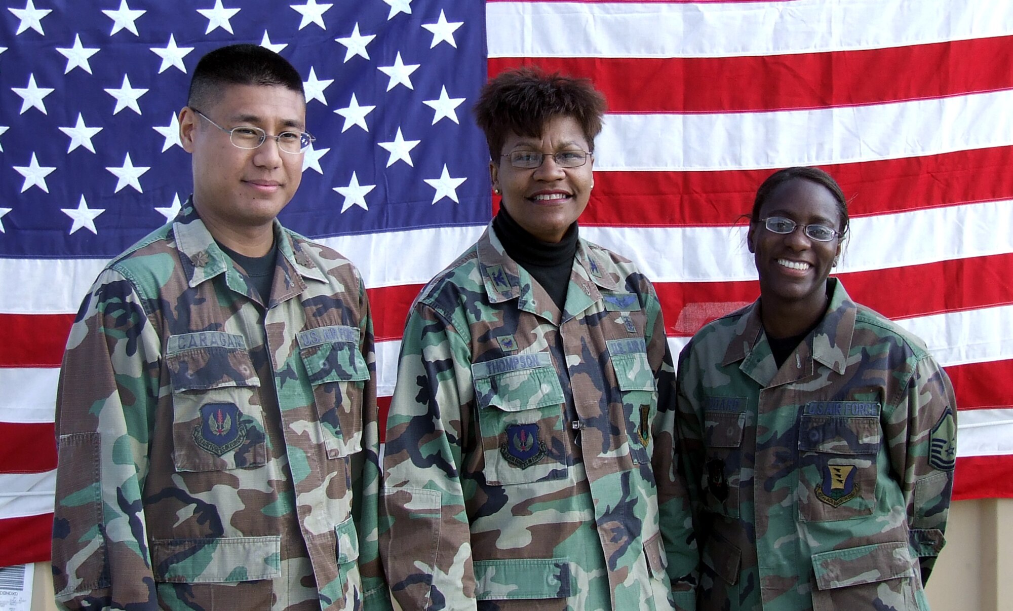 DIVULJE TRAINING BASE, Croatia – (Center) Col. Angela Thompson stands with Maj. Christopher Caragan and Master Sgt. Janet Woodard after promoting them April 30. The U.S. Air Force Airmen are deployed to the 458th Expeditionary Medical Squadron from Ramstein Air Base, Germany, to participate in Medical Training Exercise in Central and Eastern Europe 2008 (MEDCEUR 08). Fifteen nations are participating in the exercise May 2 through 14. The exercise focuses on mass-casualty training scenarios and humanitarian aid in response to crises situations. More than 400 multi-nationals are attending the exercise in support of the Partnership for Peace initiative. (U.S. Air Force photo/Chaplain (Capt.) Gabriel Rios)
