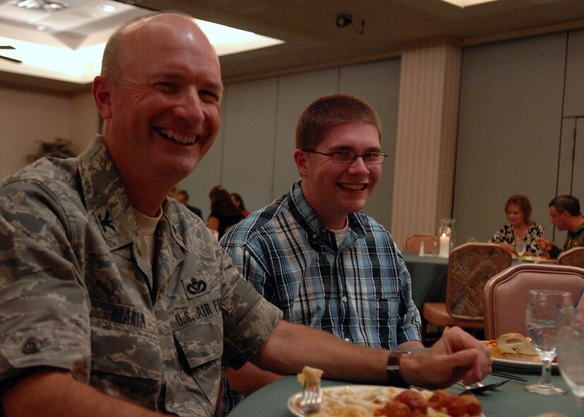 MOODY AIR FORCE BASE, Ga. -- Col. Les Martin, commander of the 23rd Mission Support Group, laughs while eating dinner with his sponsoree Drew Martin during the Moody Spouse's Club scholarship banquet here May 1. Sixteen Moody spouses and dependents were selected to receive scholarships of up to 1,000 dollars. (U.S. Air Force photo by Airman 1st Class Brittany Barker)