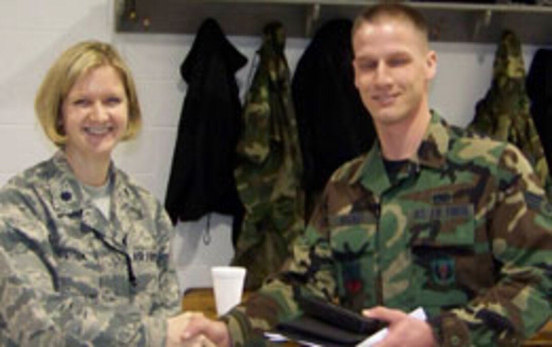 Weapons Specialist & Newly promoted SSgt Bogart receives his Academic Achievement Awards from Lt Col. Catherine Hutson, AMXS Commander.