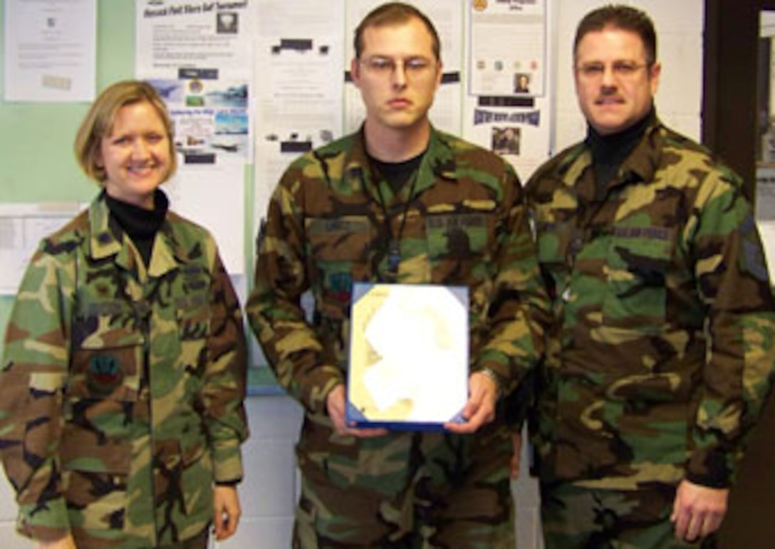 Weapons Specialist & Newly promoted SSgt James Lantz receives his Staff Sergeant Stripes from Lt Col Catherine Hutson and SMSgt David Deyo.