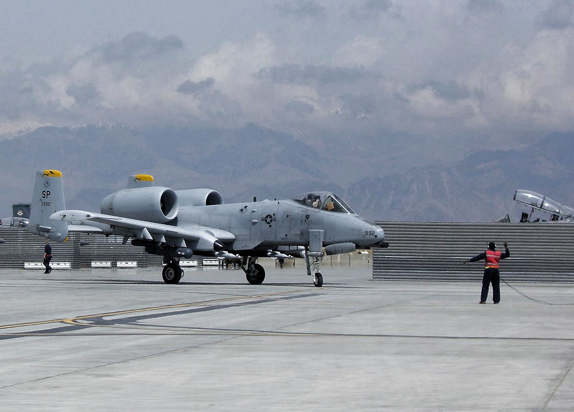 Senior Airman Troy Brown marshals an A-10 Thunderbolt II into a special area at Bagram Air Base, Afghanistan, for de-arming after a combat sortie.  Airman Brown, assigned to the 81st Expeditionary Aircraft Maintenance Unit, is deployed from Spangdahlem Air Base, Germany. (U.S. Air Force photo by Capt. Jennifer Gurganus)