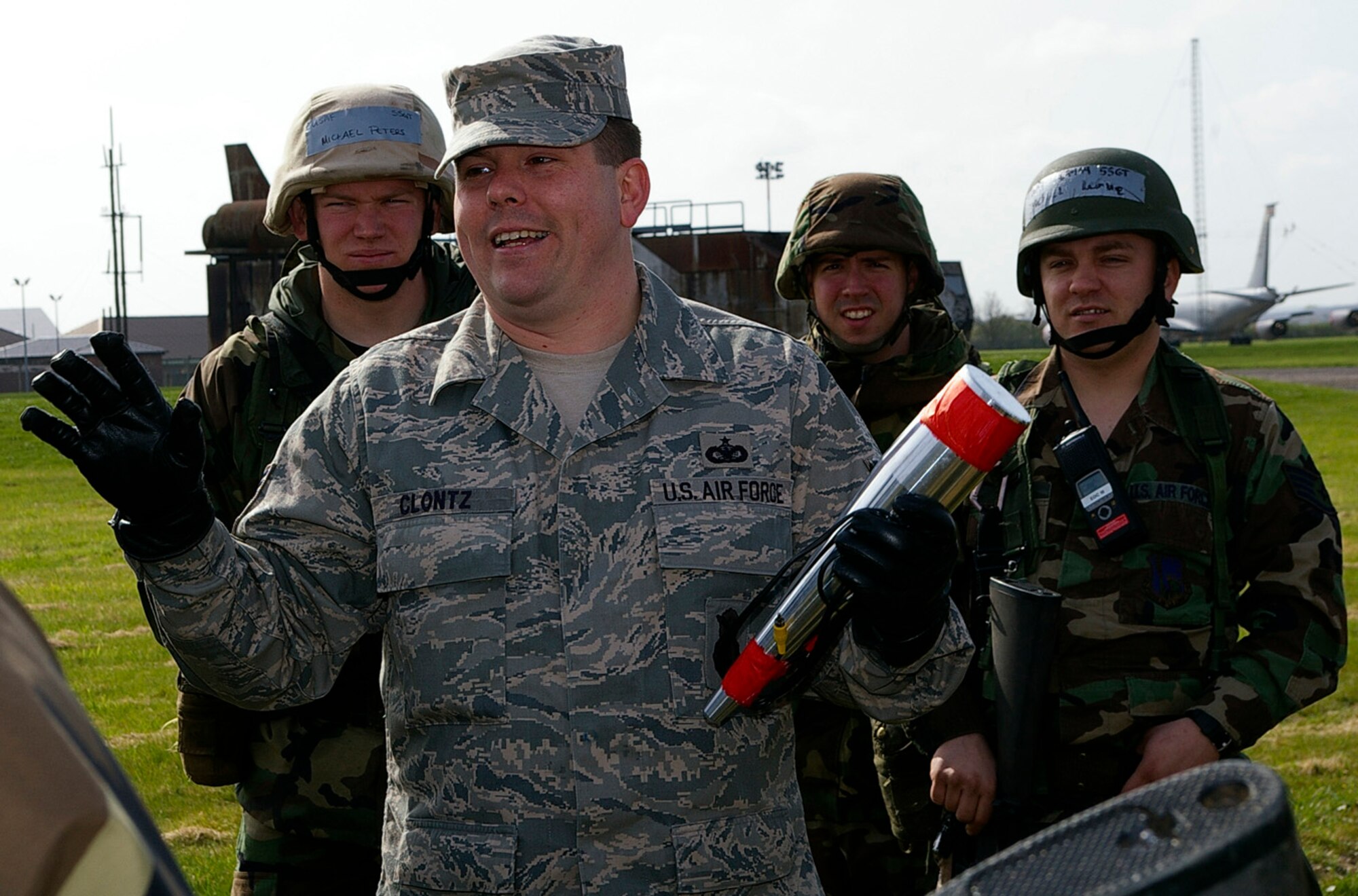 Tech. Sgt. Alan Clontz, center, 100th Security Forces Squadron, talks to 100th CES and 48th CES troops about searching for and locating improvized explosive devices. Simulated devices were placed around the area, and troops had to find them and discuss how they would flag and report them. (U.S. Air Force photo by Karen Abeyasekere)