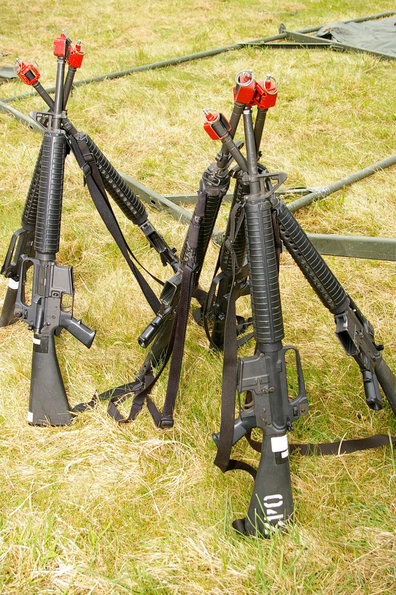M-16A2 weapons (with firing pins enabled) were stacked together for safety when 100th CES and 48th CES personnel put up tents during field training April 24. (U.S. Air Force photo by Karen Abeyasekere)