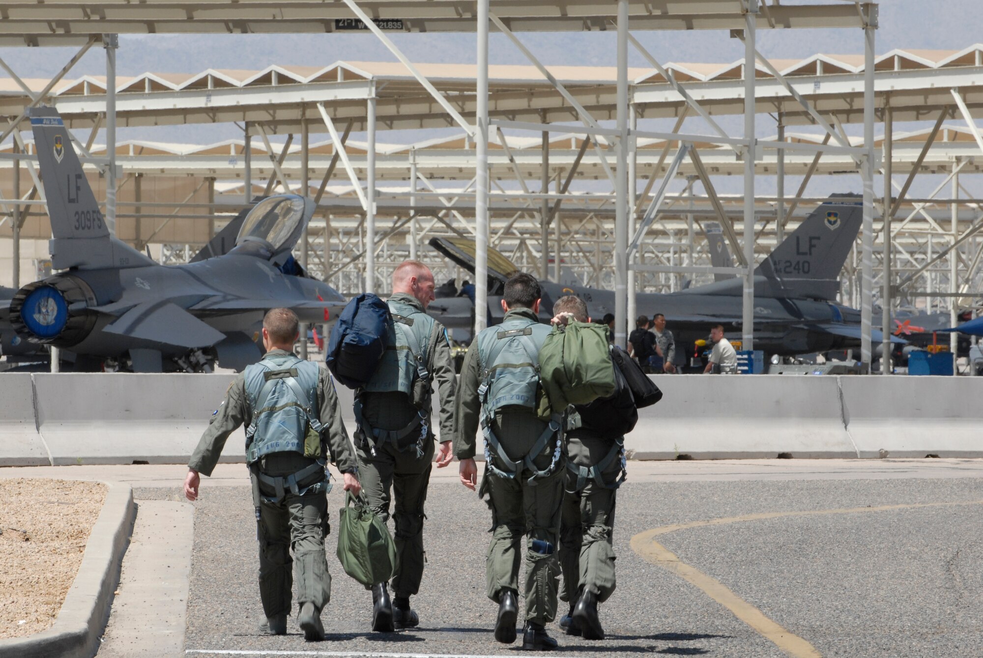 Pilots with the 309th Fighter Squadron step to their aircraft for a training mission, Apr. 28. The 309th FS is one of eight fighter squadrons that make Luke Air Force Base the largest fighter wing in the world. (U.S. Air Force photo/Staff Sergeant Christopher Hummel)