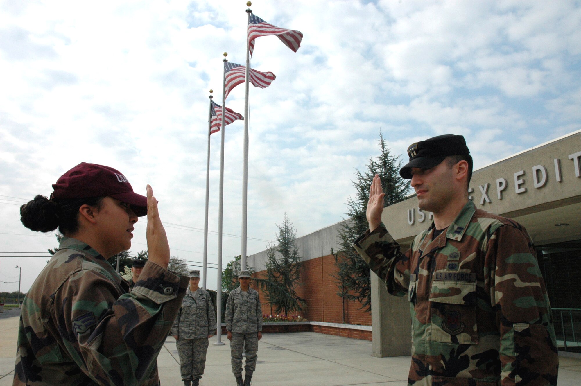Senior Airman Maria Mendez, U.S. Air Force Expeditiionary Center command section, is reenlisted by Capt. Paolino Caliendo, USAF EC judge advocate, during a ceremony in front of the USAF EC on Fort Dix, N.J., May 1, 2008.  Airman Mendez, a staff sergeant-select, was reenlinsting for the first time.  (U.S. Air Force Photo/Tech. Sgt. Scott T. Sturkol)