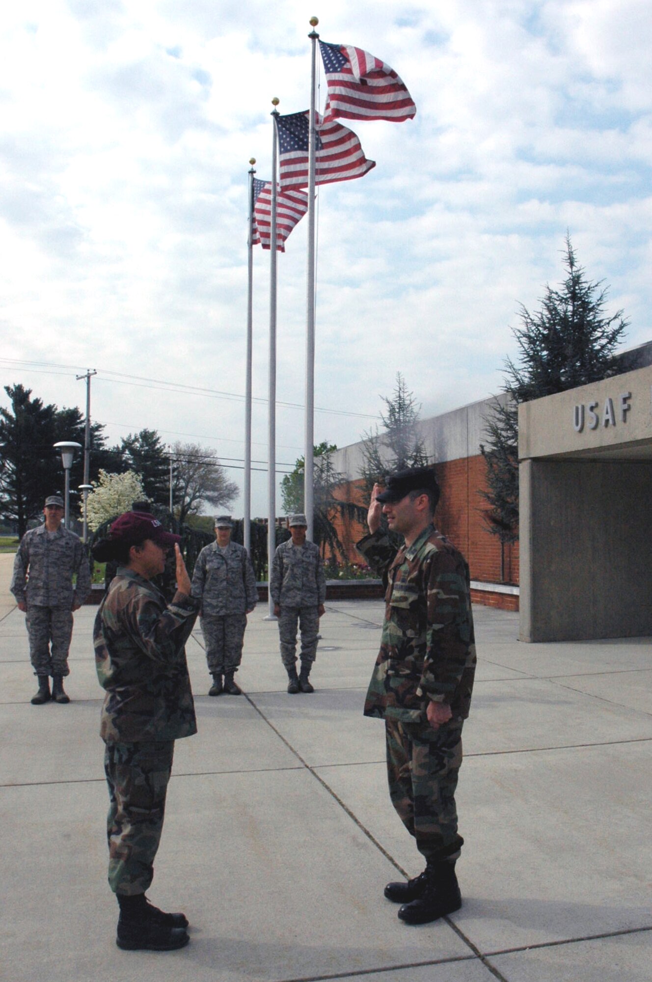Senior Airman Maria Mendez, U.S. Air Force Expeditiionary Center command section, is reenlisted by Capt. Paolino Caliendo, USAF EC judge advocate, during a ceremony in front of the USAF EC on Fort Dix, N.J., May 1, 2008.  Airman Mendez, a staff sergeant-select, was reenlinsting for the first time.  (U.S. Air Force Photo/Tech. Sgt. Scott T. Sturkol)